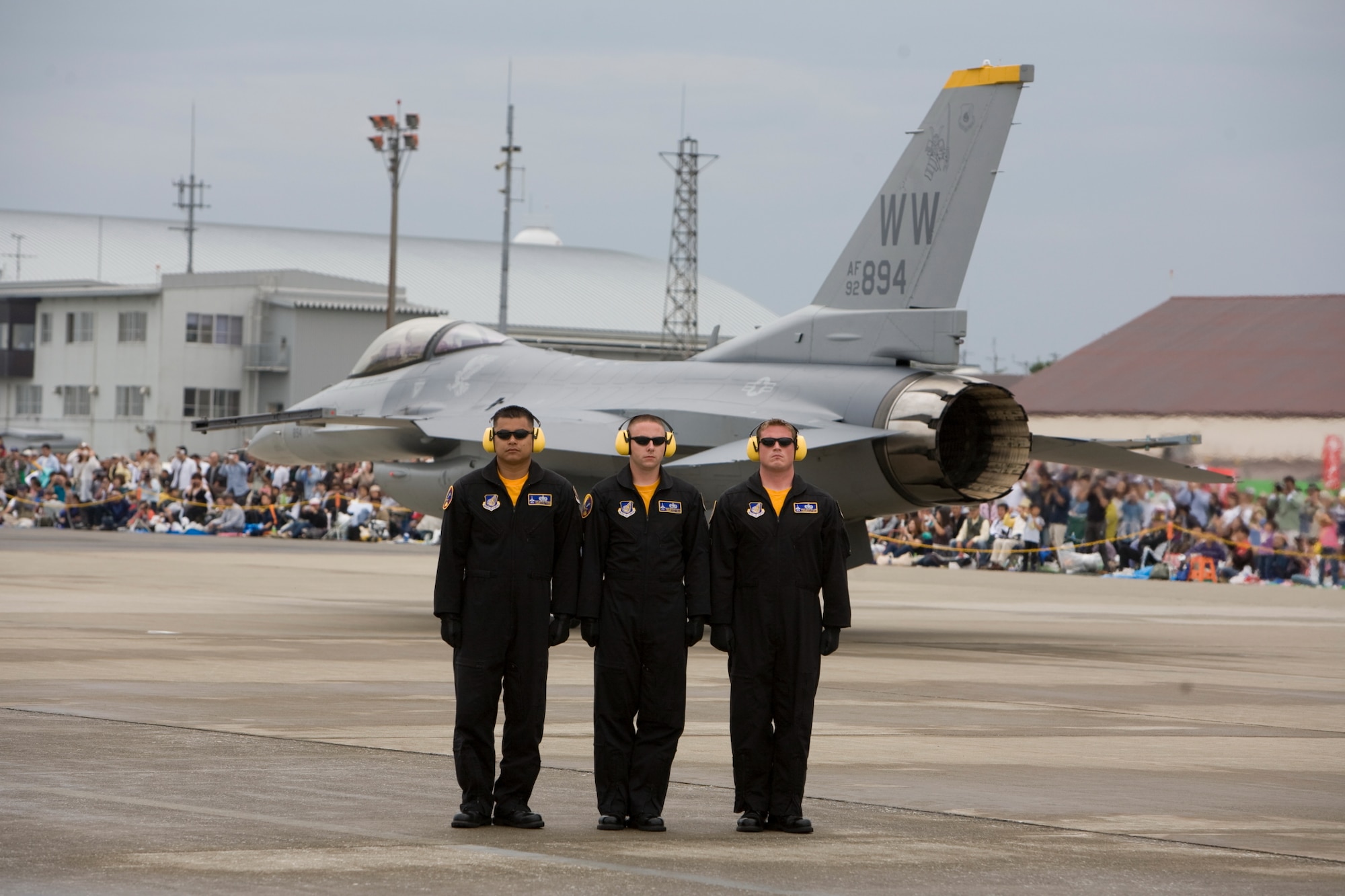 Tech. Sgt. Marlon Refugio, Staff Sgt. Michael Botti and Staff Sgt. Chad Miller, 35th Aircraft Maintenance Squadron, stand at attention as Capt. Jeffery Schneider, 35th Operations Group, taxies an F16 Fighting Flacon for takeoff.  (U.S. Air Force Photo by David Crumley/Released)