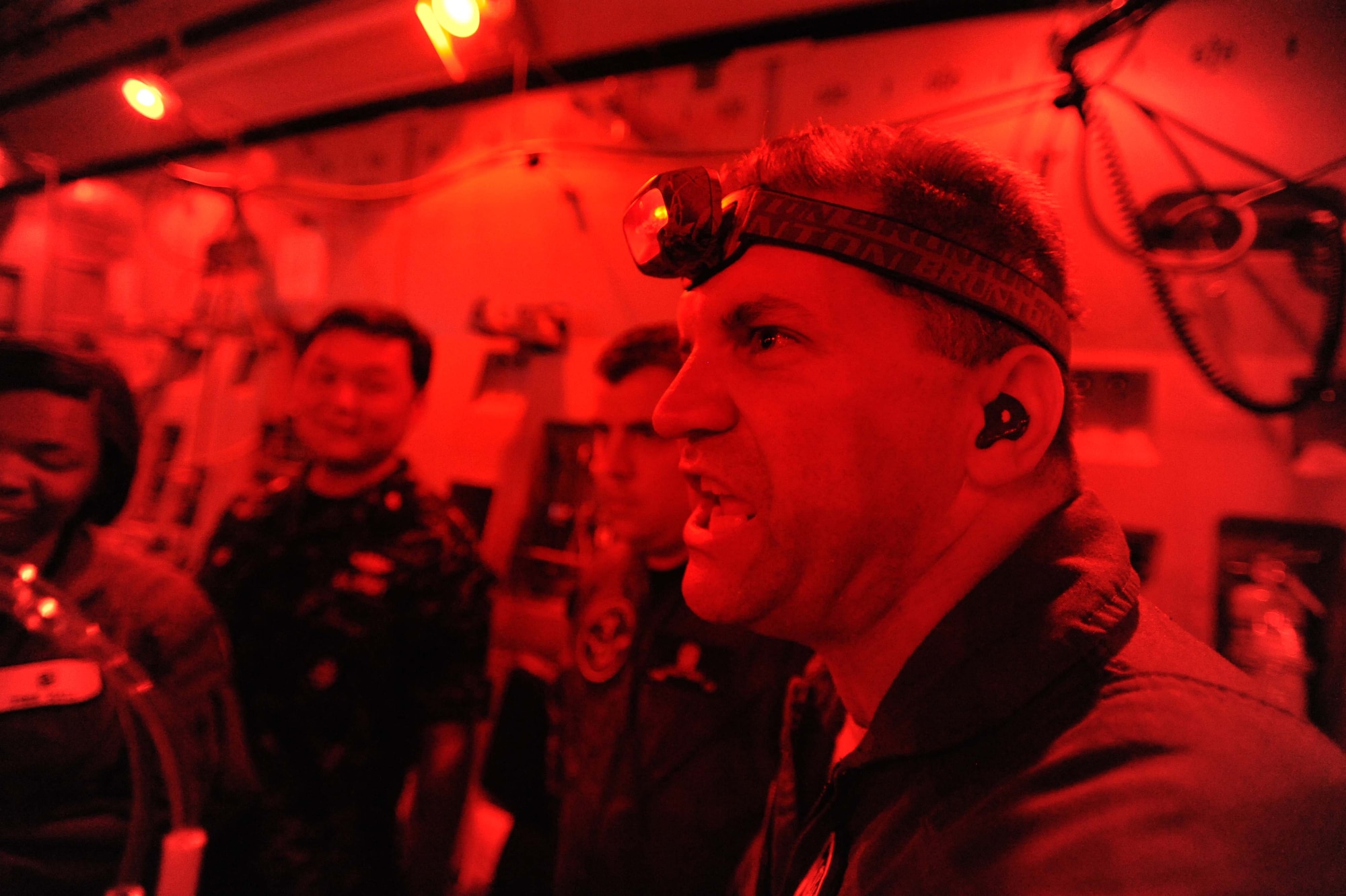 Major Mike Rebarchak, a student in the Joint Medical Attendant Transport Team class, communicates with teammates during a JMATT C-17 training flight Sept. 16. The JMATT class provides aeromedical evacuation specialists didactic, hands-on, and experiential training on critical care air transport. (U.S. Air Force photo by Staff Sgt. Nathan Allen)