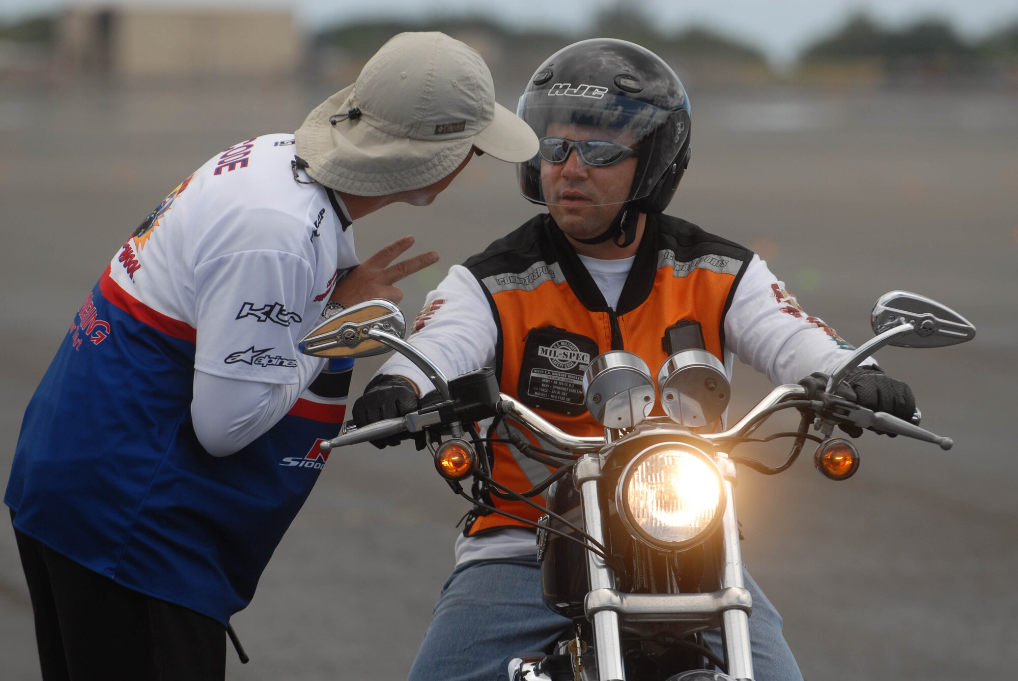Dylan Code, an instructor from the California Superbike School, provides on-the-spot feedback for a military member navigating a course on the flight line at Joint Base Pearl Harbor-Hickam, Hawaii, Sept. 15. The 15th Wing safety office hosted the Oahu-wide advanced motorcycle safety course for sister services Sept. 15 and 16. (U.S. Air Force photo/Staff Sgt. Carolyn Viss)