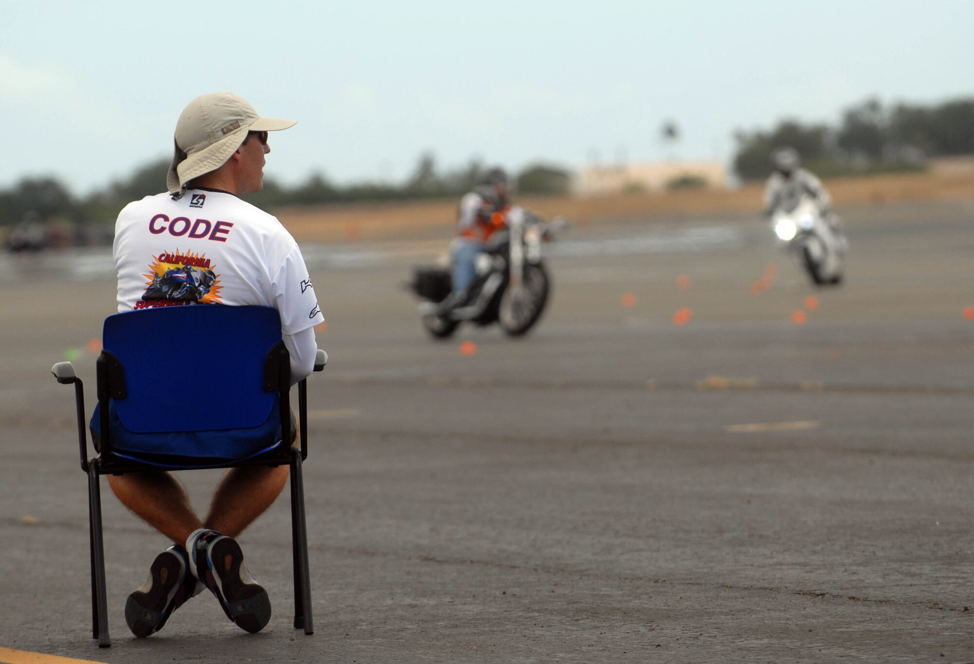 Dylan Code, an instructor from the California Superbike School, observes a group of joint-service military members as they navigate a course during an advanced motorcycle safety course Sept. 15. The 15th Wing safety office hosted the Oahu-wide event at Joint Base Pearl Harbor-Hickam. (U.S. Air Force photo/Staff Sgt. Carolyn Viss)