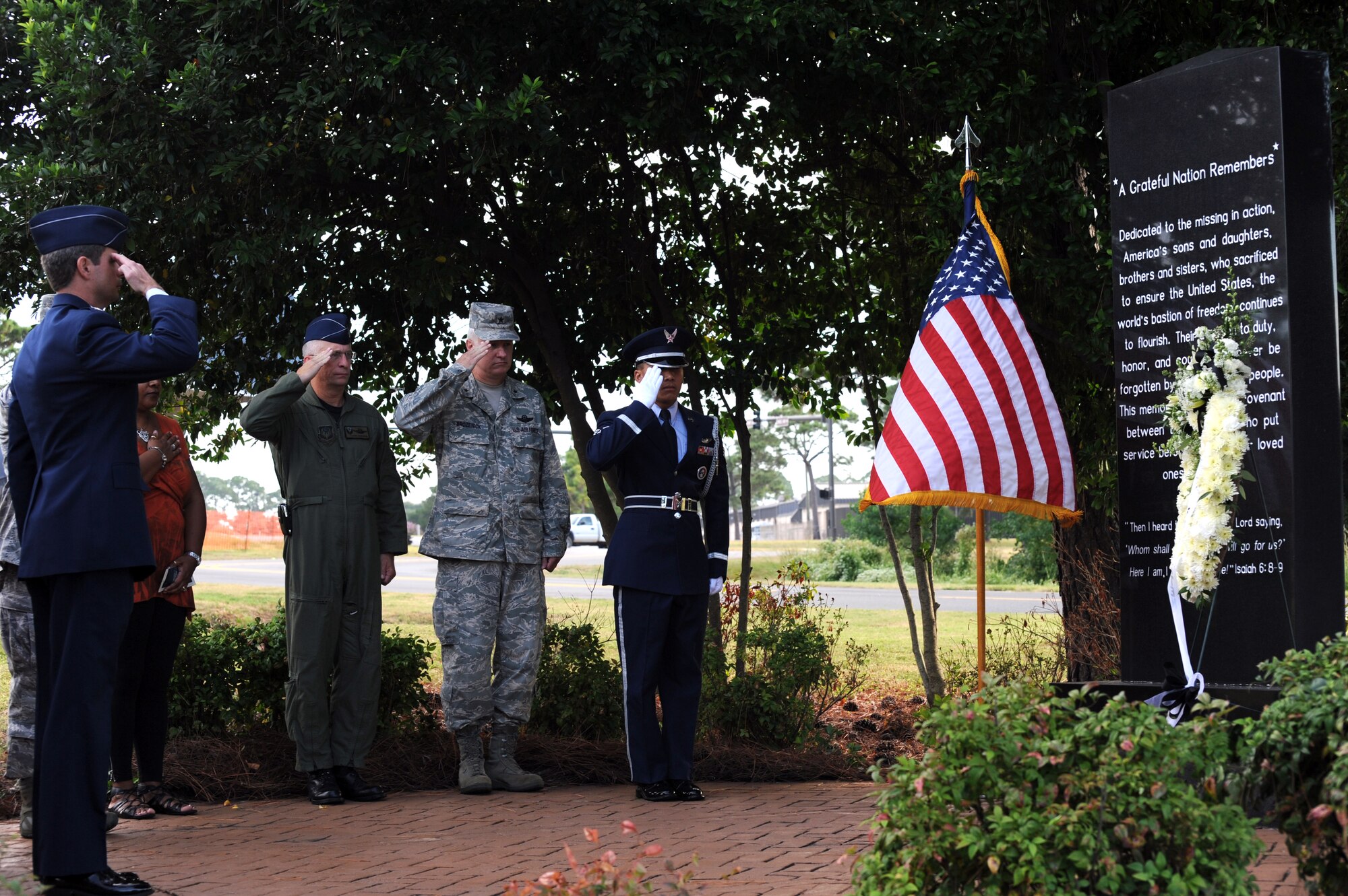 (From left to right) Col. Michael Plehn, 1st Special Operations Wing commander, Col. Hank Sanders, Air Force Special Operations Command director of staff, Brig. Gen. Norm Brozenick, AFSOC Headquarters director of plans, programs, requirements and assessment, and Senior Airman Thirasack Bone, 1st SOW Honor Guard, render salutes as Taps is played during a remembrance ceremony at the Airpark at Hurlburt Field, Fla., Sept. 17, 2010. The base held the event along with other military installations, schools and veteran’s halls across the country in observance of National POW/MIA Recognition Day.  (DoD photo by U.S. Air Force Airman 1st Class Caitlin O'Neil-McKeown) (RELEASED)