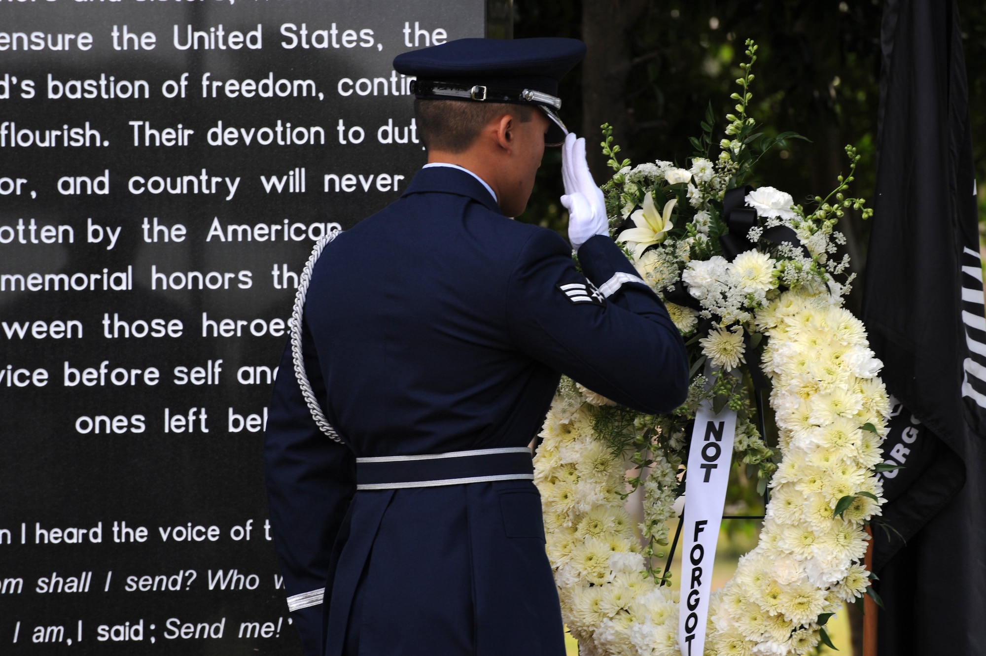 Senior Airman Thirasack Bone, 1st Special Operations Wing Honor Guard, renders a salute to a memorial wreath during a remembrance ceremony at the Airpark at Hurlburt Field, Fla., Sept. 17, 2010. The base held the event along with other military installations, schools and veteran’s halls across the country in observance of National POW/MIA Recognition Day.  (DoD photo by U.S. Air Force Airman 1st Class Caitlin O'Neil-McKeown) (RELEASED)