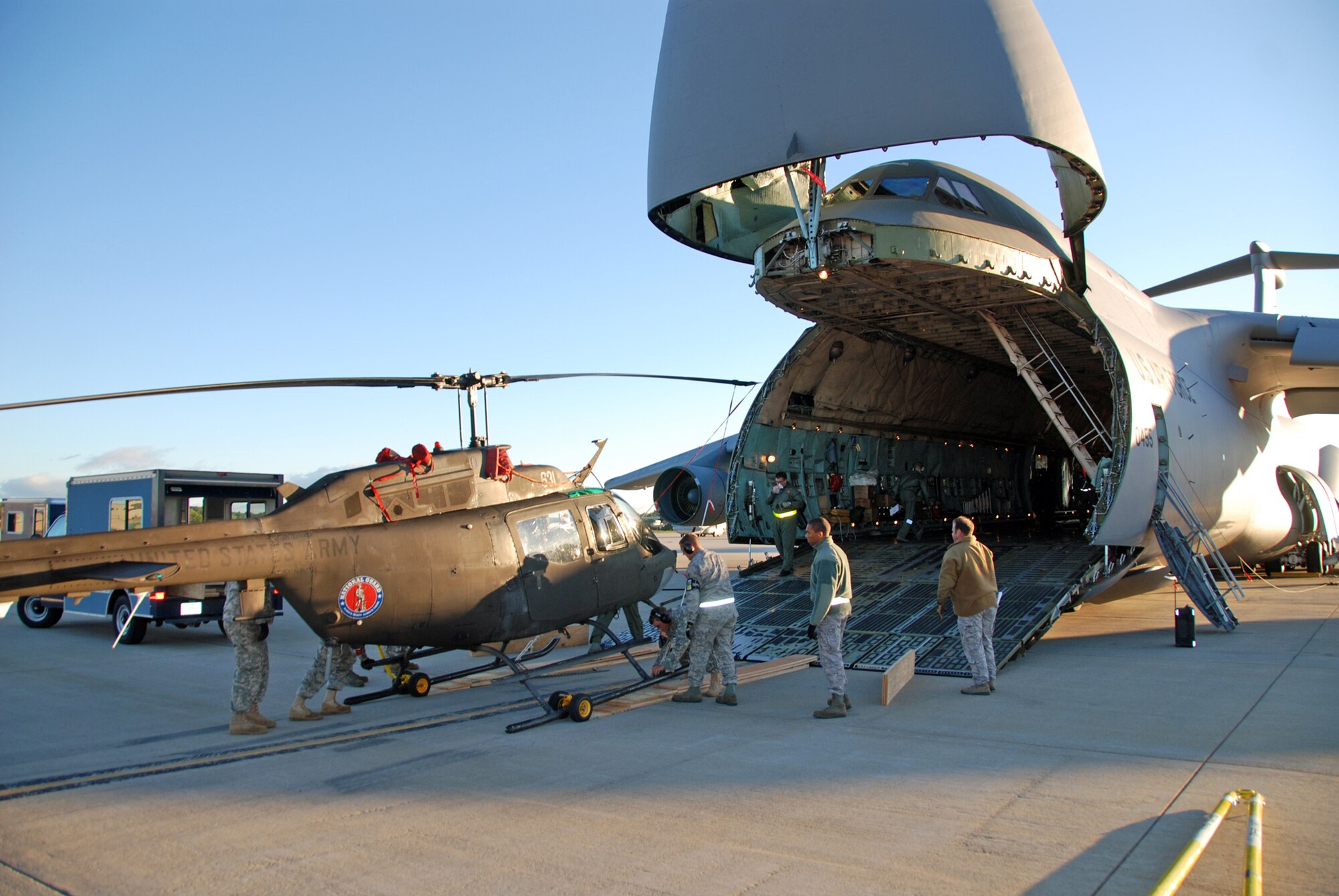 New York Army National Guard Soldier unload an OH-58 Kiowa Sept.17, 2010, at Cape Town International Airport, South Africa, from a C-5 Galaxy. (U.S. Army photo/Chief Warrant Officer 3 Aaron Teichner)