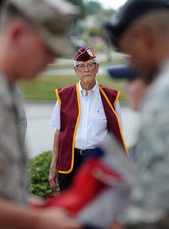 Lt. Col. (Ret.) Ernest Jenkins observes as representatives from all military branches fold the American flag during a Prisoner of War/Missing in Action retreat ceremony on Joint Base Charleston, S.C., Sept. 17, 2010.The retreat commenced after the end of a 24-hour, joint-service run, which kept military service flags and the POW/MIA flag in constant motion. Colonel Jenkins, a former prisoner of war, was detained in Bath, Germany, during World War II after his B-17 was shot down. He was imprisoned for 17 months. Colonel Jenkins was a bombardier on the B-17 "Stardust." (U.S. Air Force photo/Senior Airman Timothy Taylor)