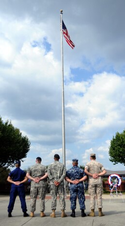 Representatives from all military branches stand at ease before retiring the American flag during a Prisoner of War/Missing in Action retreat ceremony on Joint Base Charleston, S.C., Sept. 17, 2010. A member from each military service was chosen to retire the flag in honor of all those who perished while in captivity, paying the ultimate price for liberty. (U.S. Air Force photo/Senior Airman Timothy Taylor)