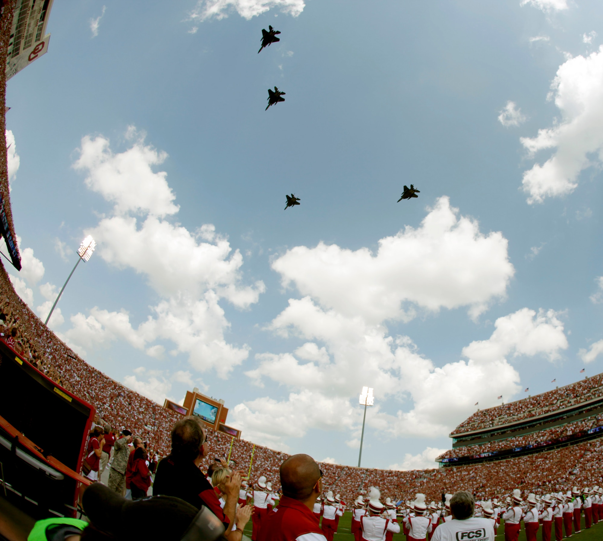 Fans watch as four F-15E Strike Eagles out of Mountain Home Air Force Base, Idaho do a flyover before the first half of the college football game between the University of Oklahoma Sooners (OU) and the Air Force Falcons at the Gaylord Family - Memorial Stadium in Norman, Okla., Sept 18.  Col. Ron Buckely, 366th Fighter Wing commander led the formation. (Courtesy photo by Bryan Terry)