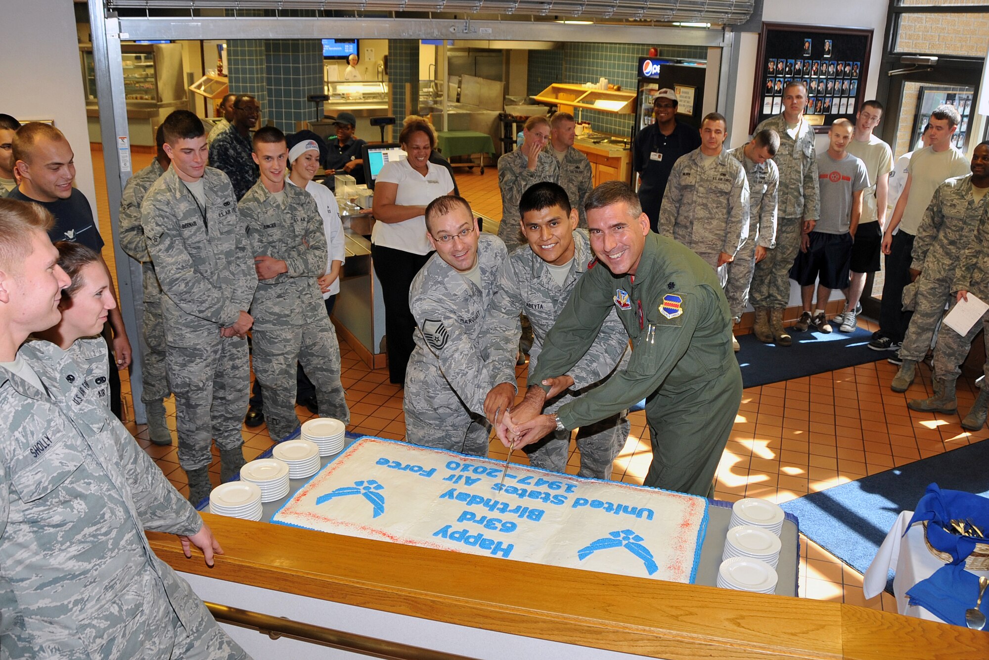 OFFUTT AIR FORCE BASE, Neb. - Master Sgt. Randy Marquart, non-commissioned officer in charge of the King Dining Facility, Airman Chad Abeyta 83rd Aircraft Maintenance Unit crew chief and Lt. Col. John Cooper, 55th Operations Group vice commander cut the birthday cake in honor of the U.S. Air Force's 63rd birthday Sept. 17 at the King Dining Facility here. 