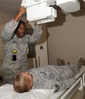 MINOT AIR FORCE BASE, N.D. -- Staff Sgt. Job Stringfellow, 5th Medical Support Squadron radiologist, uses an Arcoma X-ray machine to produce scans of Staff Sgt. Carla Hisghman, 5th MDSS radiologist, here Sept. 9. The 5th MDSS radiology shop supports the health of 5th Bomb Wing and 91st Missile Wing Airmen and family members who are all integral to the Air Force Global Strike Command mission. (U.S. photo by Airman 1st Class Aaron-Forrest Wainwright)