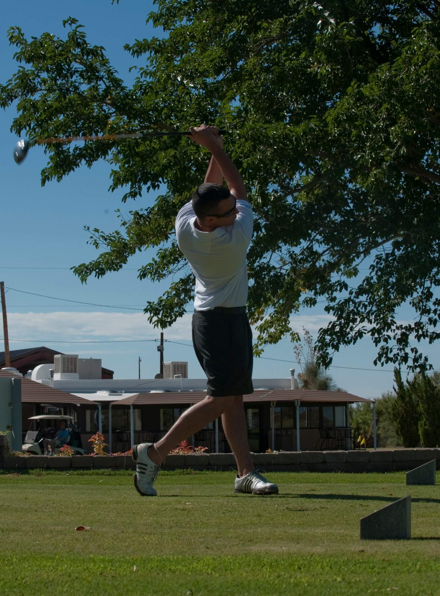 HOLLOMAN AIR FORCE BASE, N.M. -- Airman 1st Class William Wright, 49th Operation Support Squadron, follows through after hitting a golf ball during the nine-hole golf competition on Sports Day Sept. 17, 2010. Sports day is an annual event held by the Domenici Fitness and Sports Center, which allows personnel from different squadrons to compete against one another for awards and trophies. (U.S. Air Force photo by Airman 1st Class Joshua Turner / Released)