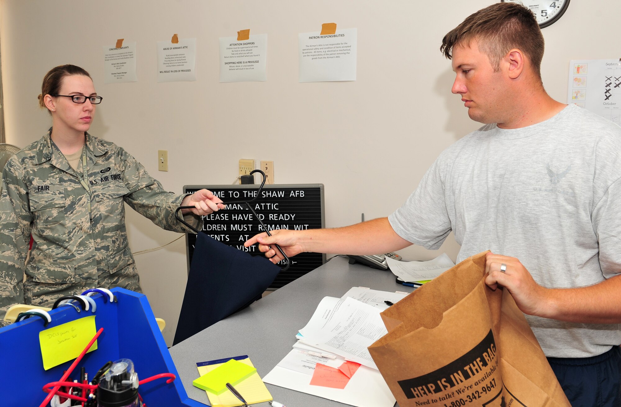 100921-F-8430J-013
SHAW AIR FORCE BASE, S.C. - Airman Wilborn Hutcheson, 20th Medical Support Squadron medical logistics, bags a pair of slacks for Airman 1st Class Lauren Fair, United States Air Force Central imagery analyst, at the Airmen's Attic, Shaw Air Force Base, S.C., Sept. 21, 2010. The Airmen's Attic depends on volunteers to help keep the facility running by sorting donations, taking out trash and keeping the facility clean. The Airmen's Attic helps Airmen and families by offering shopping and enhances their quality of life at no cost. The new facility is centrally located next to the Base Exchange and is open every Tuesday and Thursday from 11 a.m. to 1 p.m. (U.S. Air Force photo/Airman 1st Class Amber E. Jacobs (Released))