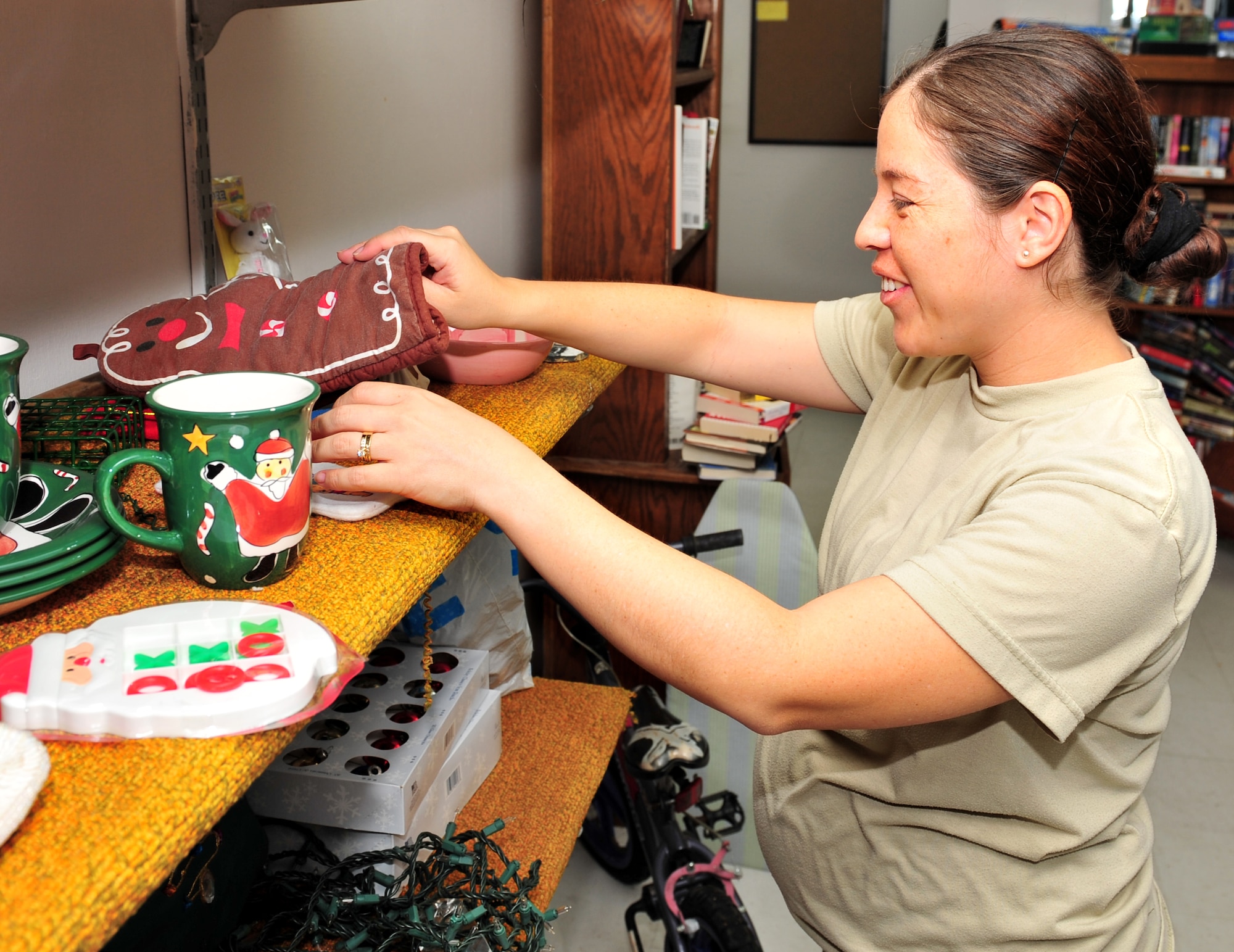 100921-F-8430J-001
SHAW AIR FORCE BASE, S.C. - Airman 1st Class Maribel Gonzalez, 20th Medical Group X-ray technician, organizes holiday items at the Airmen's Attic, Shaw Air Force Base, S.C., Sept. 21, 2010. The Airmen's Attic depends on volunteers to help keep the facility running by sorting donations, taking out trash and keeping the facility clean. The Airmen's Attic helps Airmen and families by offering shopping and enhances their quality of life at no cost. The new facility is centrally located next to the Base Exchange and is open every Tuesday and Thursday from 11 a.m. to 1 p.m. (U.S. Air Force photo/Airman 1st Class Amber E. Jacobs (Released))