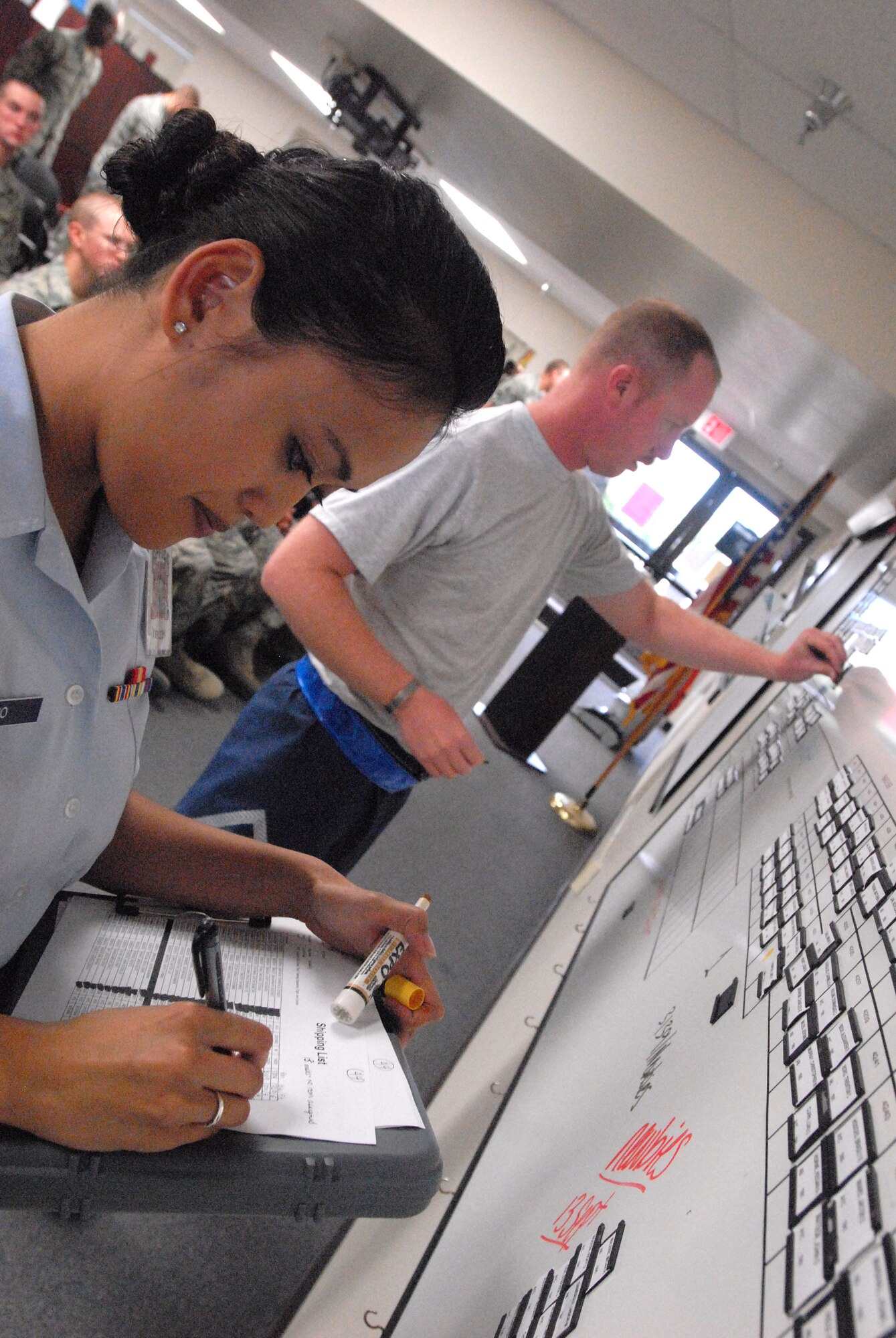 GOODFELLOW AIR FORCE BASE, Texas - Tech. Sgt. David Alonso, 315th Training Squadron Military Training Leader, takes a moment before going to physical training to help Airman Elspeth Moleno assign rooms to Airman fresh from Basic Military Training at Lackland Air Force Base in San Antonio after their arrival here for technical training Sept 20.  MTL’s are a key part of an Airman’s military training. The Air Education and Training Command Special Duty Team visited Goodfellow Tuesday and spoke about special duty an Air Force Recruiter, Military Training Instructor and Military Training Leader.  Air Force members who may have missed the team’s visit can contact Master Sgt. Kenneth Guise at (325) 654-3589, or stop by building 901 for more information. (U.S. Air Force photo/Master Sgt. Randy Mallard)