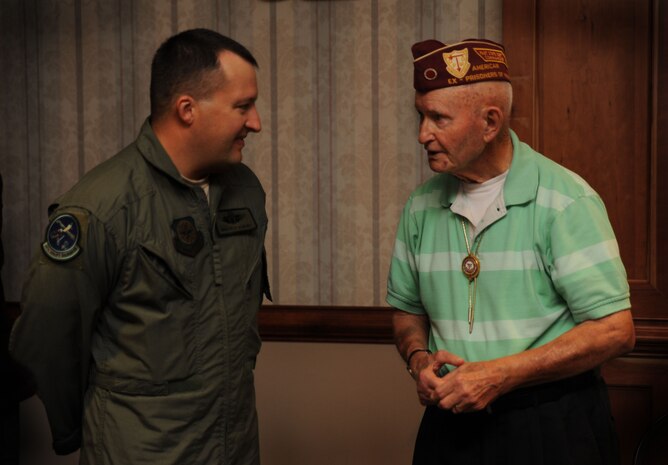 Master Sgt. Pete Scheidt, a loadmaster with the 14th Airlift Squadron, gets an earful as Master Sgt. (Ret.) Ed Flanders recounts stories from his military service and captivity during World War II at the Prisoner of War/Missing in Action luncheon on Joint Base Charleston, S.C., Sept. 17, 2010. Mr. Flanders served 22 years in the U.S. Army as a combat medic. His military career spanned both World War II and the Korean War. Three days before Christmas, Mr. Flanders was captured in Belgium and held as a prisoner by Nazis until he was liberated five months later by Russian soldiers. Mr. Flanders lost 30 pounds during his first month in captivity. "They didn't have to feed us, but when they did, they gave us soup. It was 90 percent water. If it wasn't for the worms in the soup, we wouldn't have had any protein," he said. Sergeant Scheidt is a loadmaster with the 14th Airlift Squadron. (U.S. Air Force photo/Airman 1st Class Lauren Main)