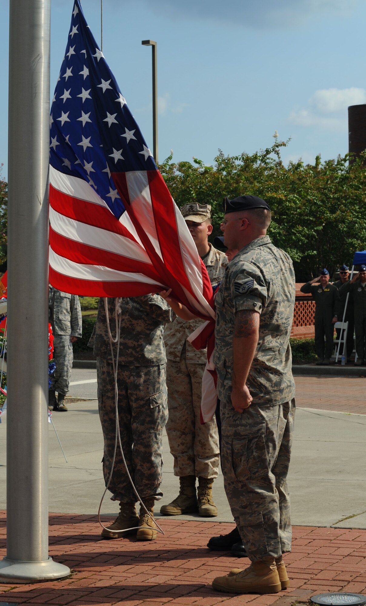 A joint-service color guard team prepares to retire the colors at a Prisoner of War/Missing in Action retreat ceremony on Joint Base Charleston, S.C., Sept. 17, 2010. The ceremony was held in honor of POW's and military members who never returned from action and paid the ultimate sacrifice for American freedom. Thirteen former POWs from the Lowcountry area were honored for their service at the retreat. The color guard consisted of members from all five military service branches assigned to the Navy Consolidated Brig and Coast Guard Sector Charleston. (U.S. Air Force photo/Airman 1st Class Lauren Main)