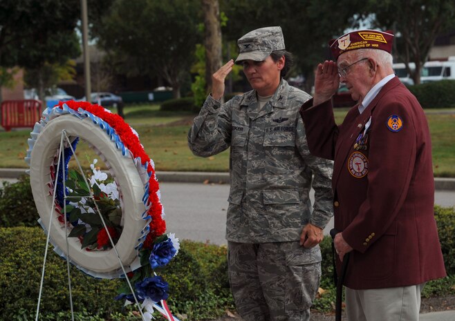 Col. Martha Meeker and Paul Hollen render salutes after laying a Prisoner of War/Missing in Action wreath on Joint Base Charleston, S.C., Sept. 17, 2010, to commemorate the sacrifices of POW/MIA heroes. The wreath is laid in memory of those who perished while in captivity, paying the ultimate price for liberty. Mr. Hollen served as a waist gunner on a B-17 when it was shot down over Germany in 1945. A rough parachute landing left Mr. Hollen face down in the German snow with a serious back injury. Nazi soldiers who found Mr. Hollen were brutal and unforgiving, he said. They took him prisoner, and he spent the next six months at a camp in Moosburg, Germany. Colonel Meeker is the 628th Air Base Wing Commander. (U.S Air Force photo/Airman 1st Class Lauren Main)