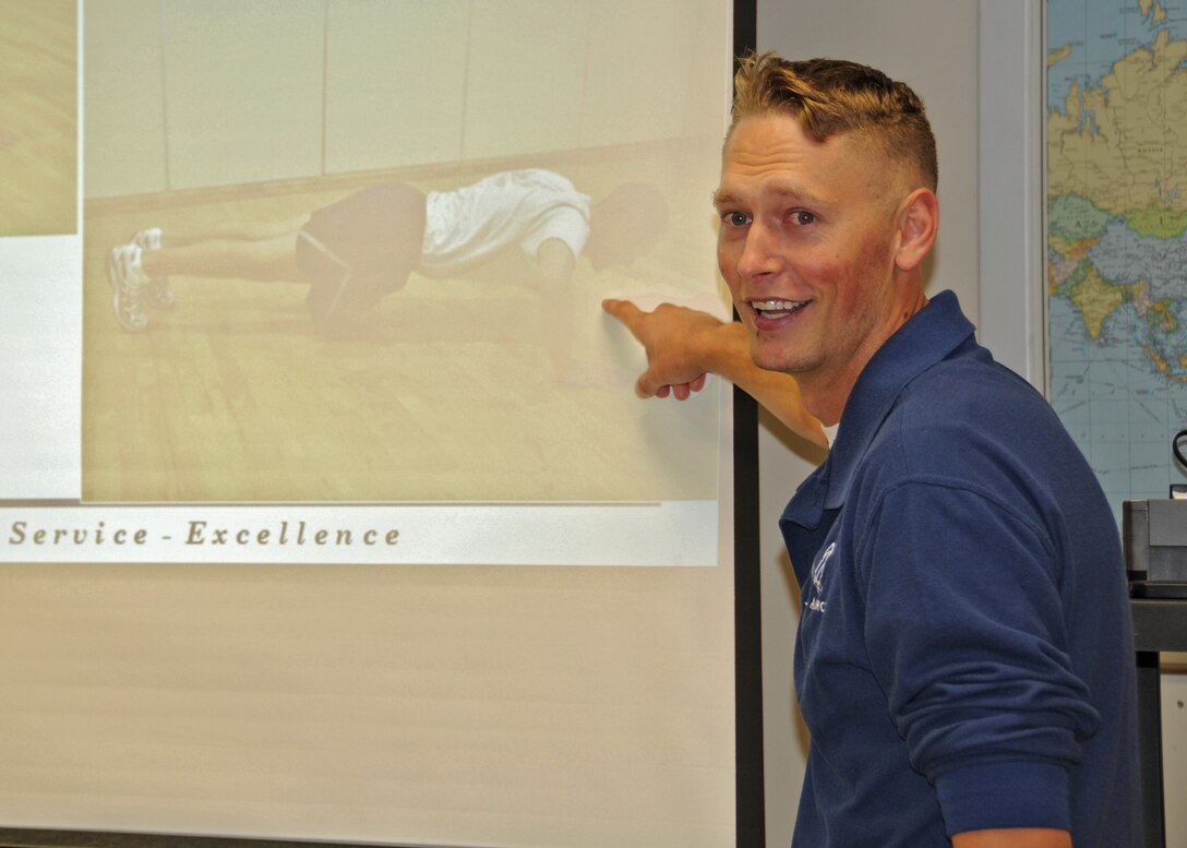 A 914th Airlift Wing fitness monitor uses powerpoint to show proper pushup techique during a Unit Fitness Monitor training session September 11, 2010, Niagara Falls Air Reserve Station, Niagara Falls N.Y. The Wing prepares for the October UTA when the 914th Airlift Wing will conduct its first mass fitness test under the new Air Force standards that came into effect in July of 2010. (U.S. Air Force photo by Staff Sgt. Joseph McKee)