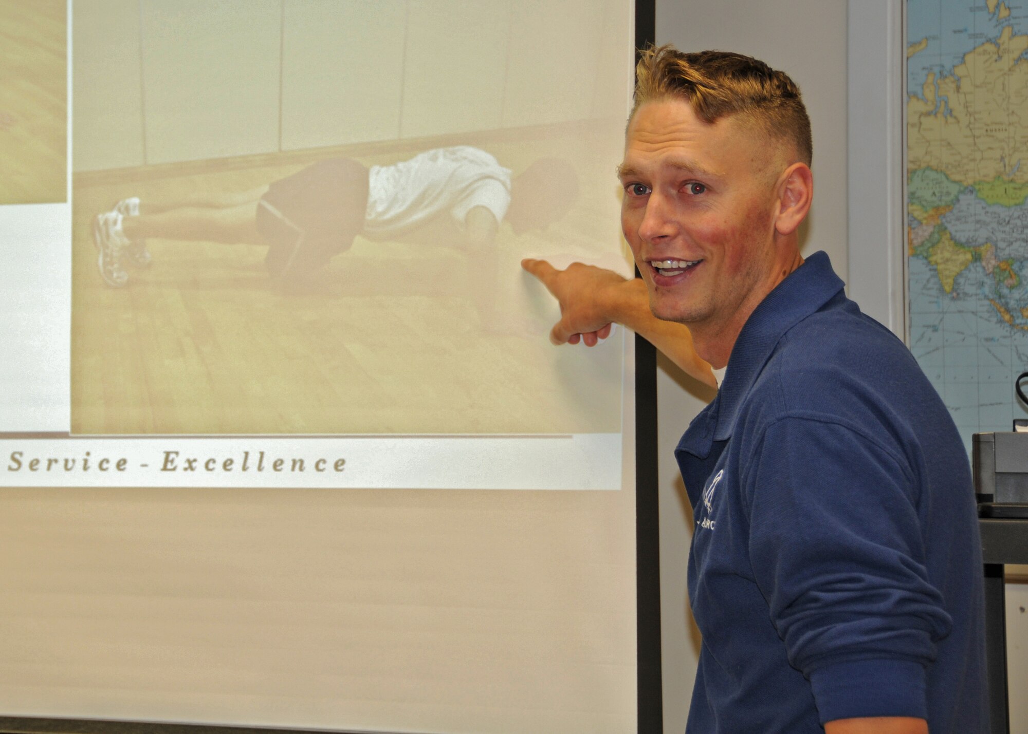 A 914th Airlift Wing fitness monitor uses powerpoint to show proper pushup techique during a Unit Fitness Monitor training session September 11, 2010, Niagara Falls Air Reserve Station, Niagara Falls N.Y. The Wing prepares for the October UTA when the 914th Airlift Wing will conduct its first mass fitness test under the new Air Force standards that came into effect in July of 2010. (U.S. Air Force photo by Staff Sgt. Joseph McKee)