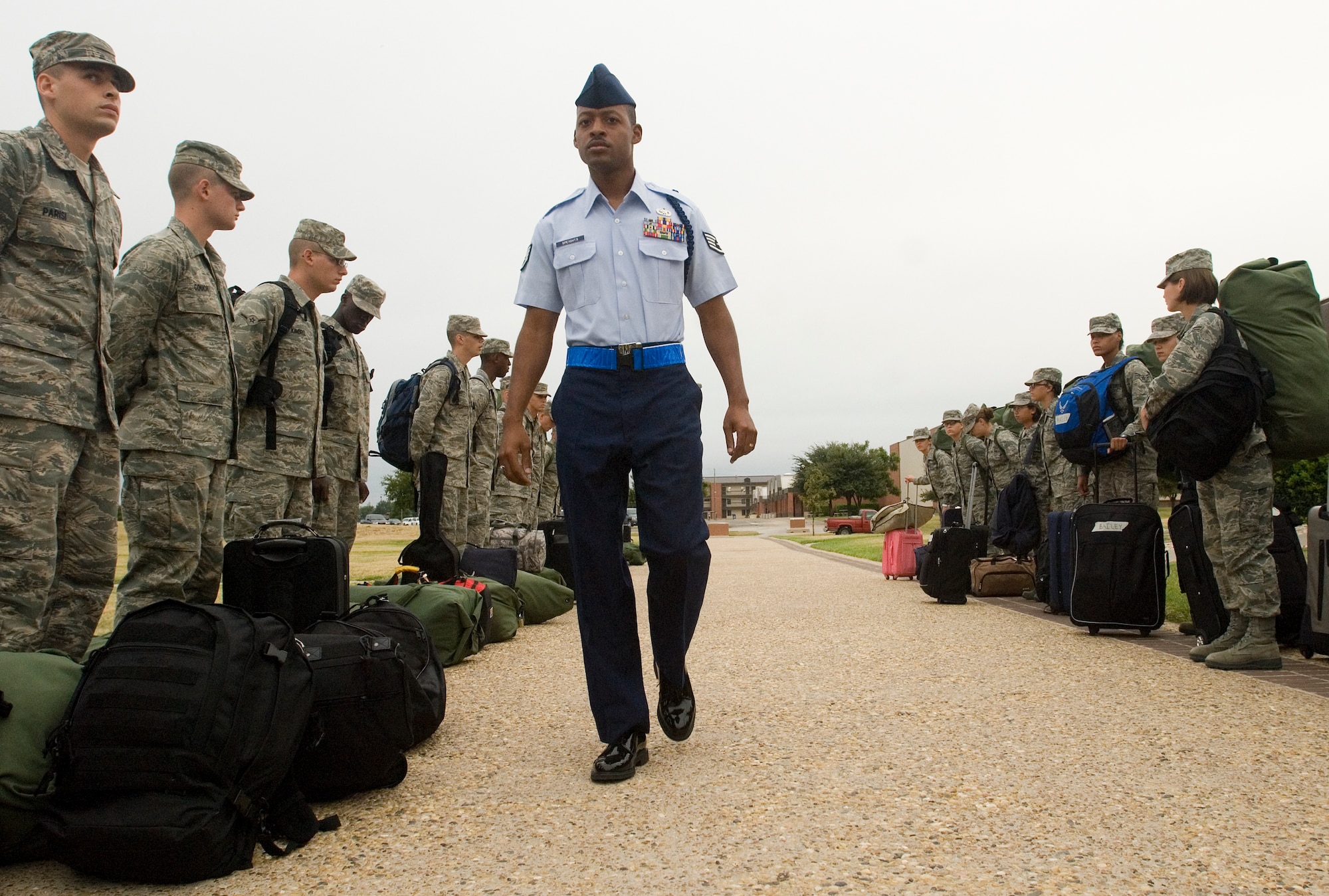 GOODFELLOW AIR FORCE BASE, Texas - Staff Sgt. Derrell Speights, 312th Training Squadron Military Training Leader, walks down a line of Airmen after their arrival here from Basic Military Training at Lackland Air Force Base in San Antonio Sept. 20.  MTL’s are a key part of an Airman’s military training. The Air Education and Training Command Special Duty Team visited Goodfellow Tuesday and spoke about special duty opportunities as an Air Force Recruiter, Military Training Instructor and Military Training Leader.  Air Force members who missed the team’s visit can contact Master Sgt. Kenneth Guise at (325) 654-3589, or stop by building 901 for more information. (U.S. Air Force photo/Master Sgt. Randy Mallard)
