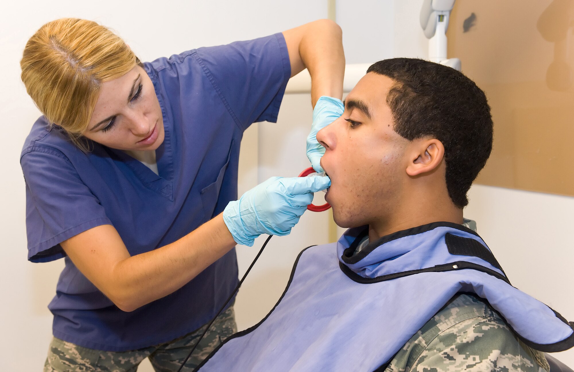 Staff Sgt. Jennifer Kelly, 512th Aerospace Medicine Squadron dental technician, takes dental X-rays on Airman 1st Class Michael Trombley, 512th Maintenance Squadron, at the Dental Clinic here during the Unit Training Assembly. Reservists are required to have a civilian dental examination annually and a military dental examination every third year. (U.S. Air Force photo by Roland Balik/Released)