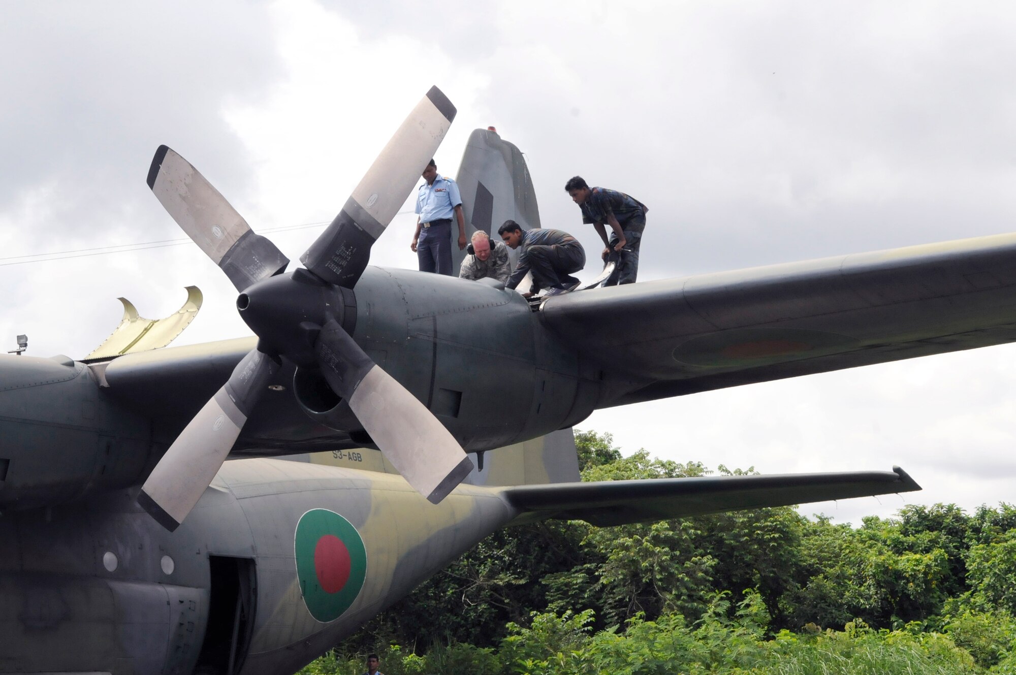 Staff Sgt. Kevin Stubblefield helps Bangladesh air force Sgts. Eakub Ali, S.M. Iqbal and Military Warrant Officer Golam Faruque troubleshoot an engine problem on a Bangladesh C-130 Hercules during exercise Cope South 10, Sept. 20, 2010, at Kurmitola Air Base, Bangledesh. The bilateral exercise's subject-matter expert exchanges in maintenance, operations and rigging disciplines strengthen the strong and growing partnership between the United States and Bangladesh. Sergeant Stubblefield is an aircraft maintainer from the 374th Maintenance Squadron at Yokota Air Base, Japan. The Bangladesh airmen are aircraft maintainers. (U.S. Air Force photo/Master Sgt. Jeffery Loftin)