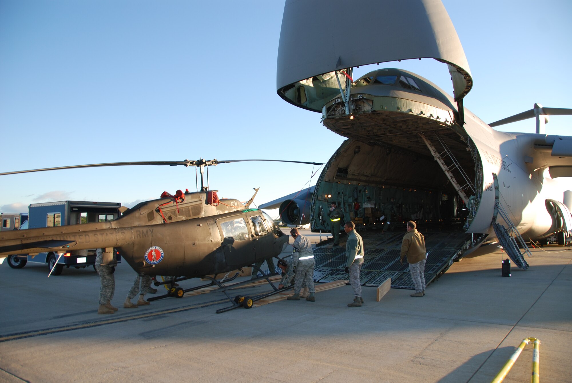 Soldiers with Detachment 1, Alpha Co, 1-224 Aviation Security and Support Battalion, New York Army National Guard unload an OH-58 Kiowa Sept.17 at Cape Town International Airport, South Africa, from a U.S. Air Force C-5 Galaxy. The New York National Guard, which participates in a State Partnership Program with the South African National Defence Force, is participating in the African Aerospace Defence Exposition 2010. (Courtesy photo by Chief Warrant Officer 3 Aaron Teichner)