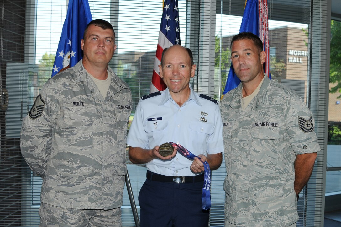 McGHEE TYSON AIR NATIONAL GUARD BASE, Tenn. - Staff members of The I.G. Brown Air National Guard Training and Education Center (L-R) Master Sgt. Jason Wolfe, NCOIC, infrastructure management for the communications focal point section; Col. Brad McRee, project officer; and Tech. Sgt. John Temple, Wilson Hall operations manager, show the medal they received for participating in the 2010 Air Force Marathon, in the foyer of Patriot Hall here, Sept. 20, 2010.  The 2010 Air Force Marathon was held at Wright-Patterson AFB, Ohio, Sept. 17-18, 2010.  (U.S. Air Force photo by Master Sgt. Mavi Smith/Released)