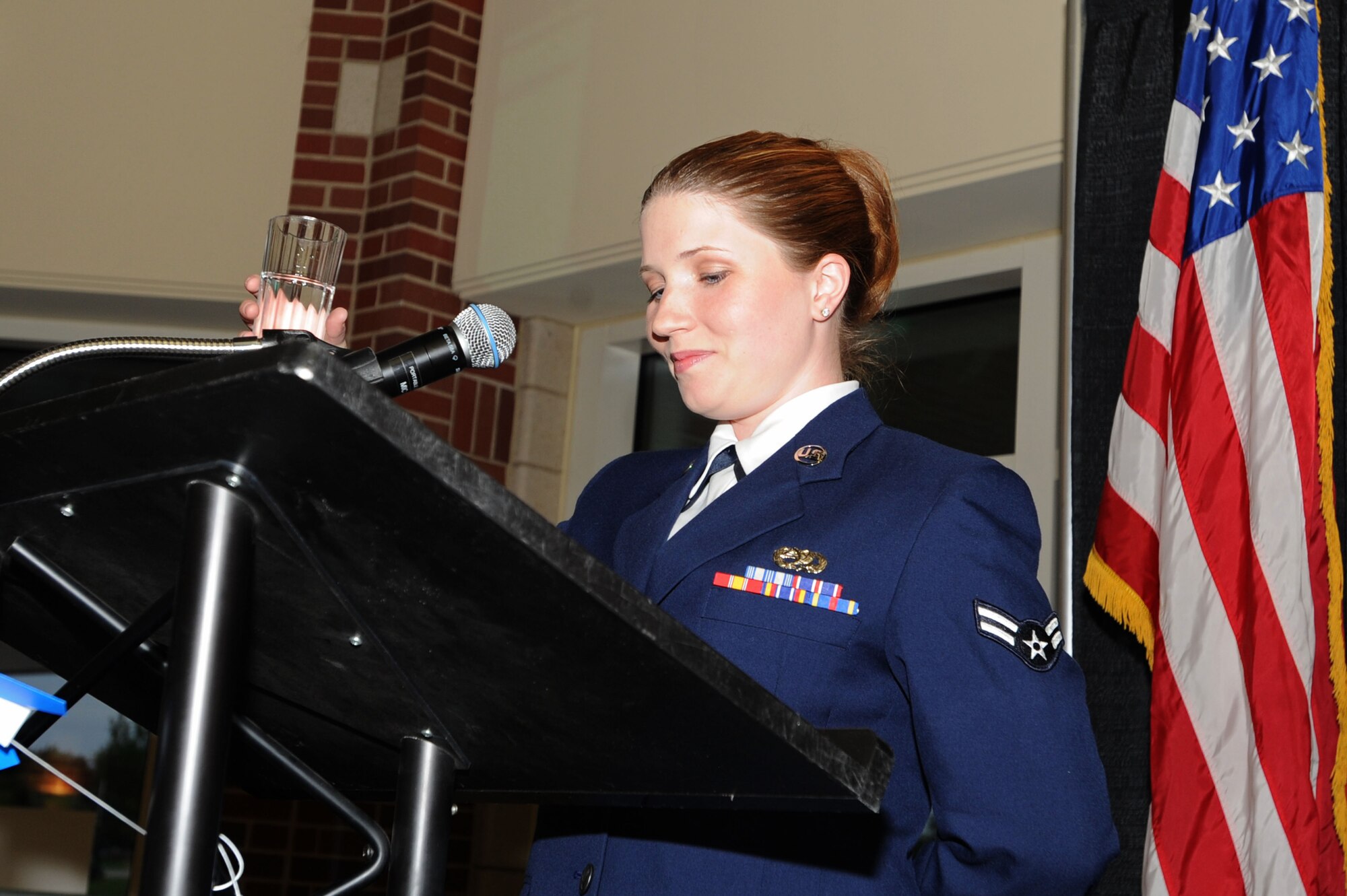 Airman 1st Class Adriana Abbott, 319th Communications Squadron, raises her water for the POW/MIA toast during the Grand Forks Air Force Base Air Force Ball Sept. 17 at the Ralph Englestad Arena in Grand Forks, N.D. The United States Air Force ended a 40-year association with the United States Army when President Harry S. Truman signed the National Security Act of 1947; Sept. 18, 2010, marked the 63rd Anniversary of the U.S. Air Force. (U.S. Air Force photo by Staff Sgt. Suellyn Nuckolls)