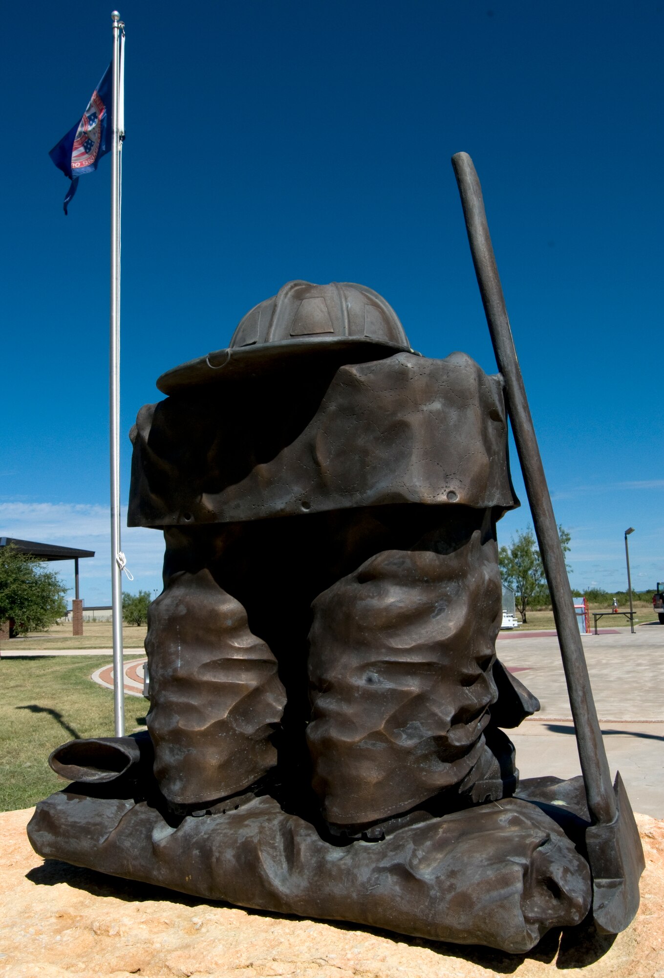GOODFELLOW AIR FORCE BASE, Texas – A bronze statue of firefighter gear stands as a symbol to remember those who have paid the ultimate sacrifice serving as a Department of Defense  firefighter. More than 100 people, including 80 motorcyclists, gathered at the memorial here during the Fifth Annual DOD Fallen Firefighter Memorial Ride Sept. 18 to pay homage. (U.S. Air Force photo/ Senior Airman Tong Duong)