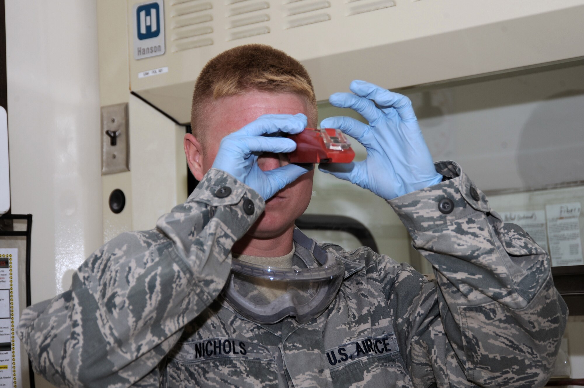 Staff Sgt. Matthew Nichols, 380th Expeditionary Logistics Readiness Squadron fuels laboratory NCO in charge, looks at the Fuel System Icing Inhibitor levels in a fuel sample Aug. 26, 2010, at an undisclosed location in Southwest Asia. (U.S. Air Force photo/Tech. Sgt. April Wickes)