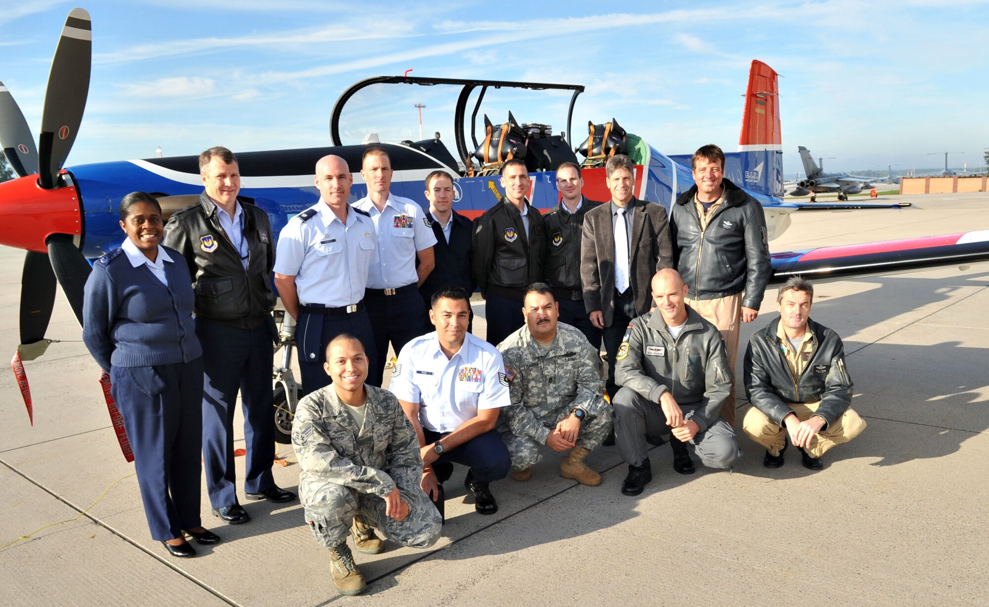 Members of the Air Ground Operation Squadron, pose in front of a Pilatus PC-9 aircraft, Ramstein Air Base, Germany, Sept. 20, 2010.  The PC-9 is one of ten aircraft owned by E.I.S. E.I.S., a local German company, has been awarded a one-year contract to fly the PC-9 capable of doing nearly everything JTAC instructor need for training certification. (U.S. Air Force photo by Airman 1st Class Desiree Esposito)