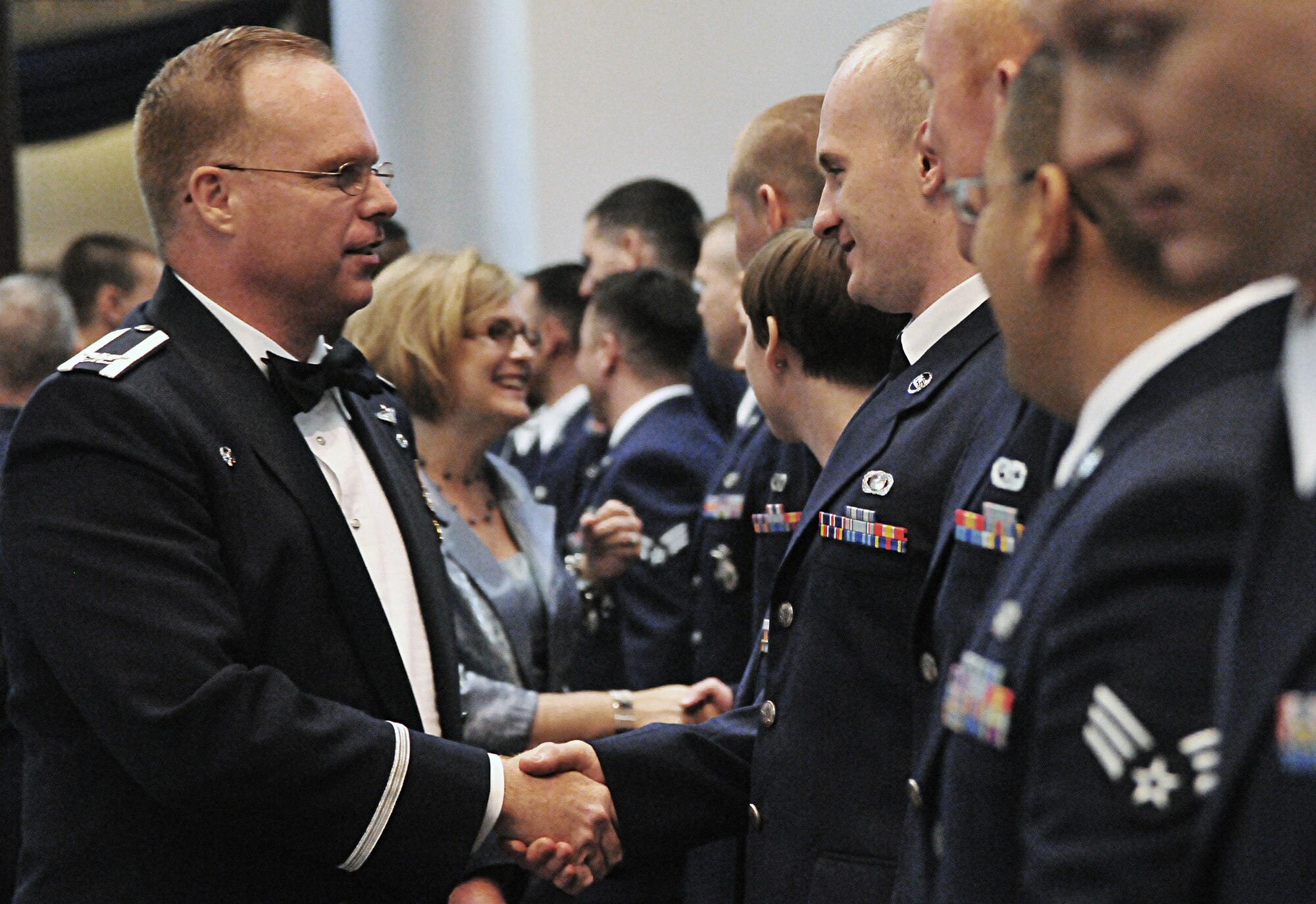 Colonel Eric Beene, 39th Air Base Wing commander, congratulates Airman Leadership School graduates after their ceremony at the consolidated club Sept. 17, 2010 at Incirlik Air Base, Turkey.  ALS is a U.S. Air Force professional military education program designed to develop Airmen into effective front-line supervisors. (U.S. Air Force photo by Senior Airman Alexandre Montes/Released)