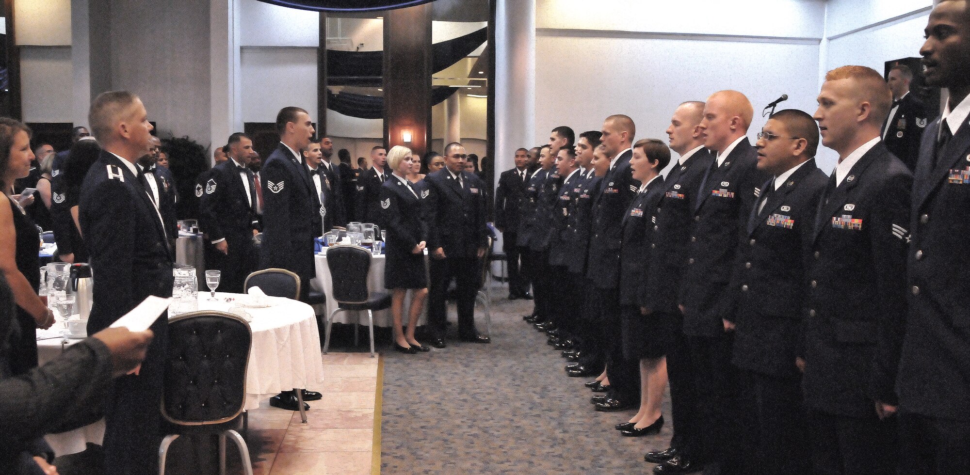 Fourteen graduates from Incirlik’s Airman Leadership School sing the Air Force Song and recite the Airman’s Creed at the consolidated club Sept. 17, 2010 at Incirlik Air Base, Turkey. The ALS graduates were Senior Airman Marie Fortenberry, Senior Airman Aaron Johnson, Senior Airman Martin Gomez III, Senior Airman Justin Lupkes, Senior Airman William Allen, Senior Airman Christina Moran, Senior Airman Brendan Victory, Senior Airman Vanessa Fisher, Senior Airman Joshua Quintanilla, Senior Airman Chase Brinton, Senior Airman Arthur Montoya, Senior Airman Ian Fuller, Senior Airman Dustin Hiatt, Senior Airman Donald Love, and Senior Airman Eric Wiltz (Not Shown). (U.S. Air Force photo by Senior Airman Alexandre Montes/Released)