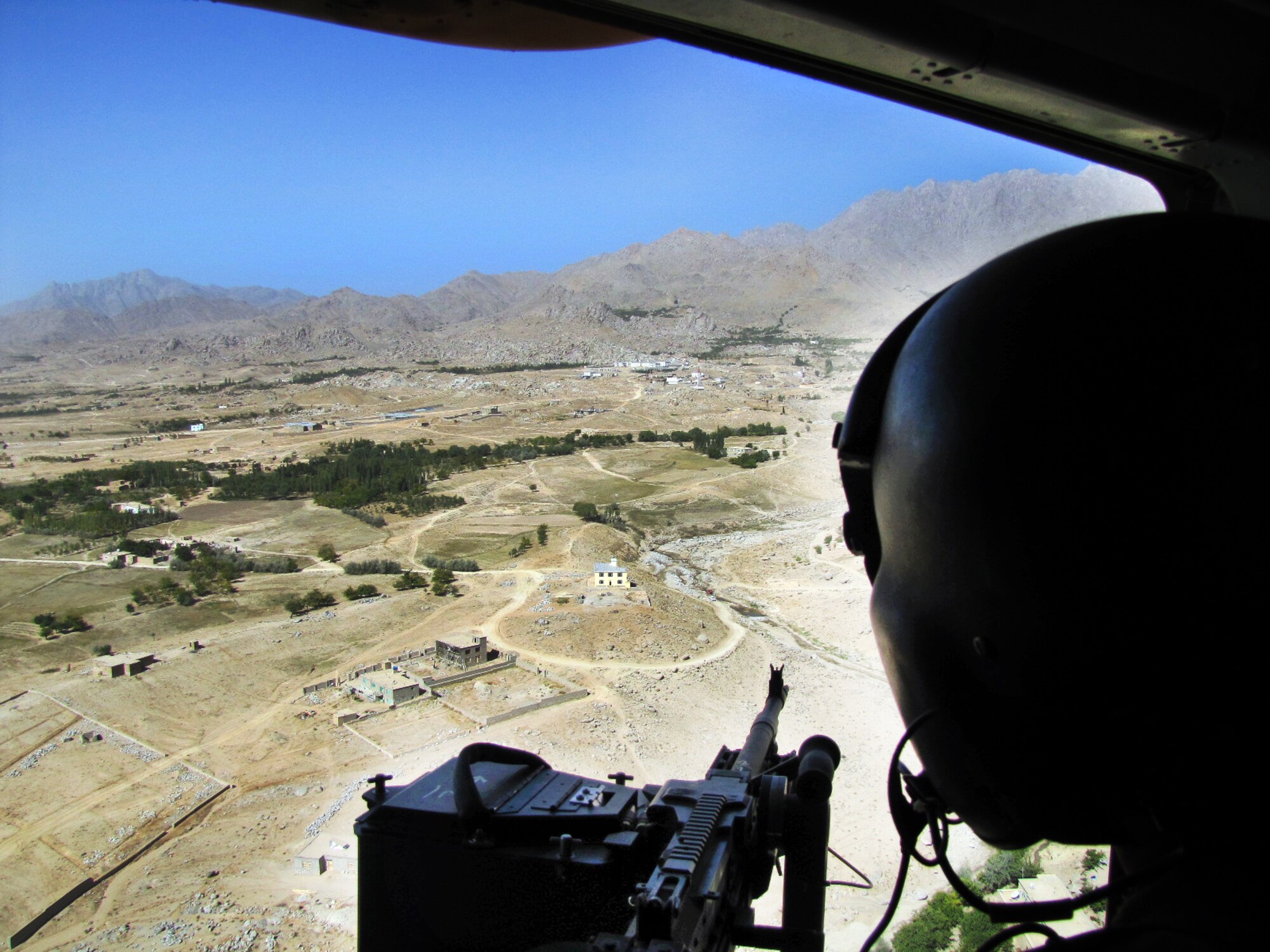 100920-F-878I-001 KABUL, Afghanistan - The gunner of an Afghan Air Force Mi-17 helicopter keeps a sharp eye on the terrain during the delivery of election ballots on Sep. 20, 2010. The AAF worked long days in order to disseminate ballots to all regions of Afghanistan. These efforts lead to a 40 percent turnout by Afghan citizens. (US Air Force photo by Technical Sergeant Tony Iusi/ RELEASED).