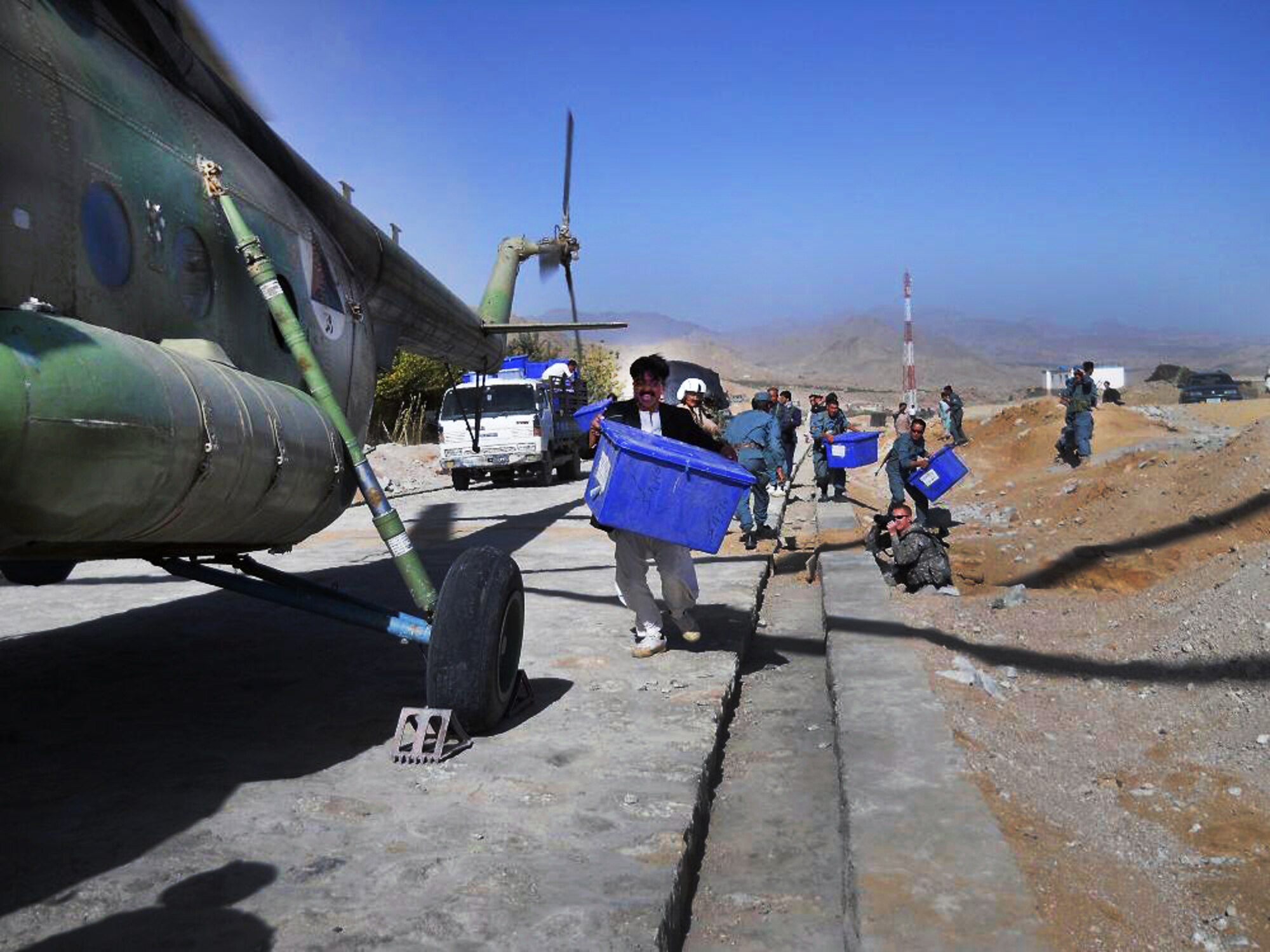 100920-F-4747G-003 KABUL, Afghanistan - Afghan residents of the regions west of Ghazni work to load election ballots onboard Afghan Air Force Mi-17 helicopters on Sep. 20, 2010. The AAF worked long days in order to disseminate ballots to all regions of Afghanistan. These efforts lead to a 40 percent turnout by Afghan citizens. (US Air Force photo by Chief Master Sergeant Max Grindstaff/ RELEASED).