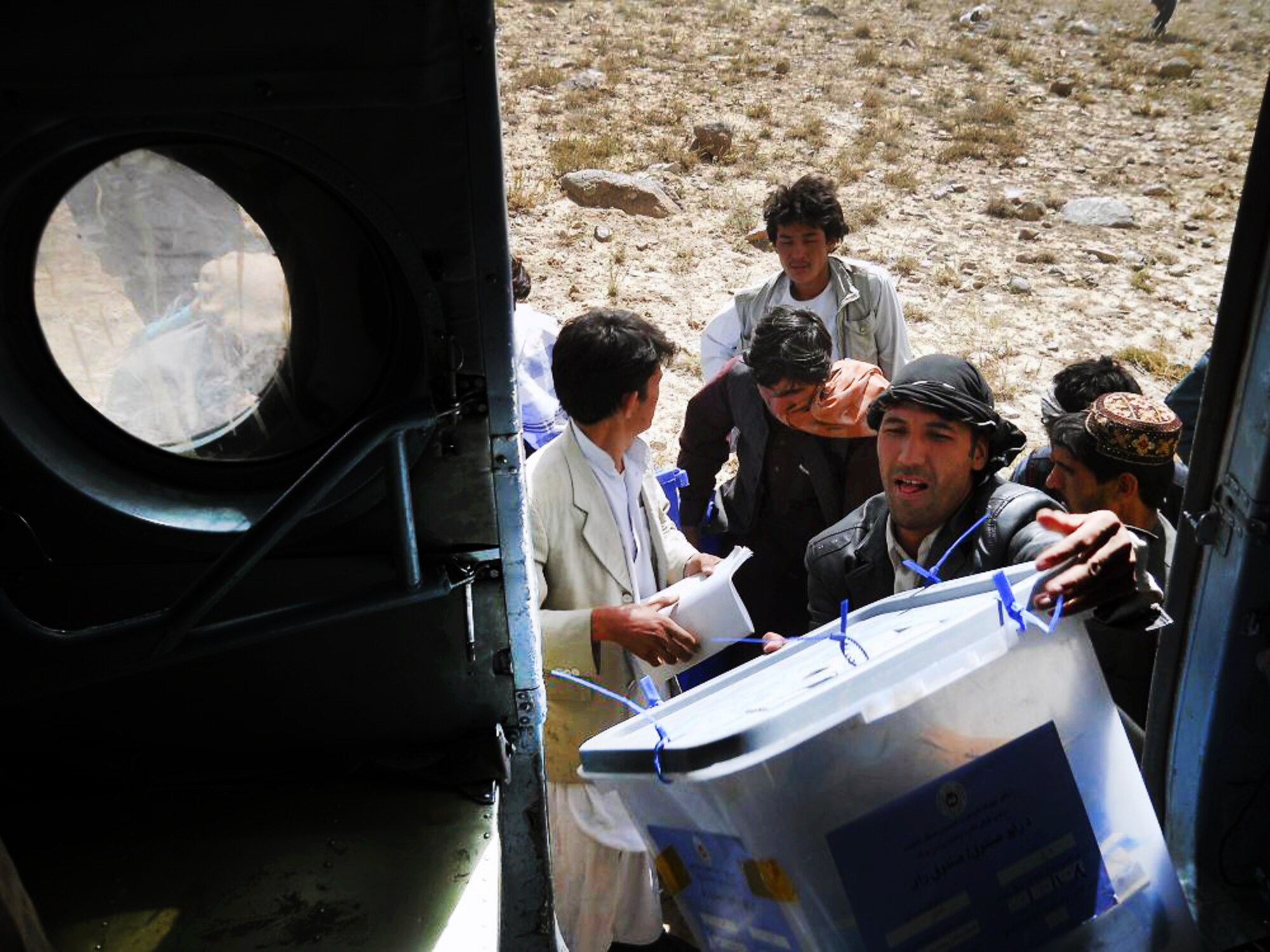 100920-F-4747G-002 KABUL, Afghanistan - Afghan residents of the regions west of Ghazni work to load election ballots onboard Afghan Air Force Mi-17 helicopters on Sep. 20, 2010. The AAF worked long days in order to disseminate ballots to all regions of Afghanistan. These efforts lead to a 40 percent turnout by Afghan citizens. (US Air Force photo by Chief Master Sergeant Max Grindstaff/ RELEASED).