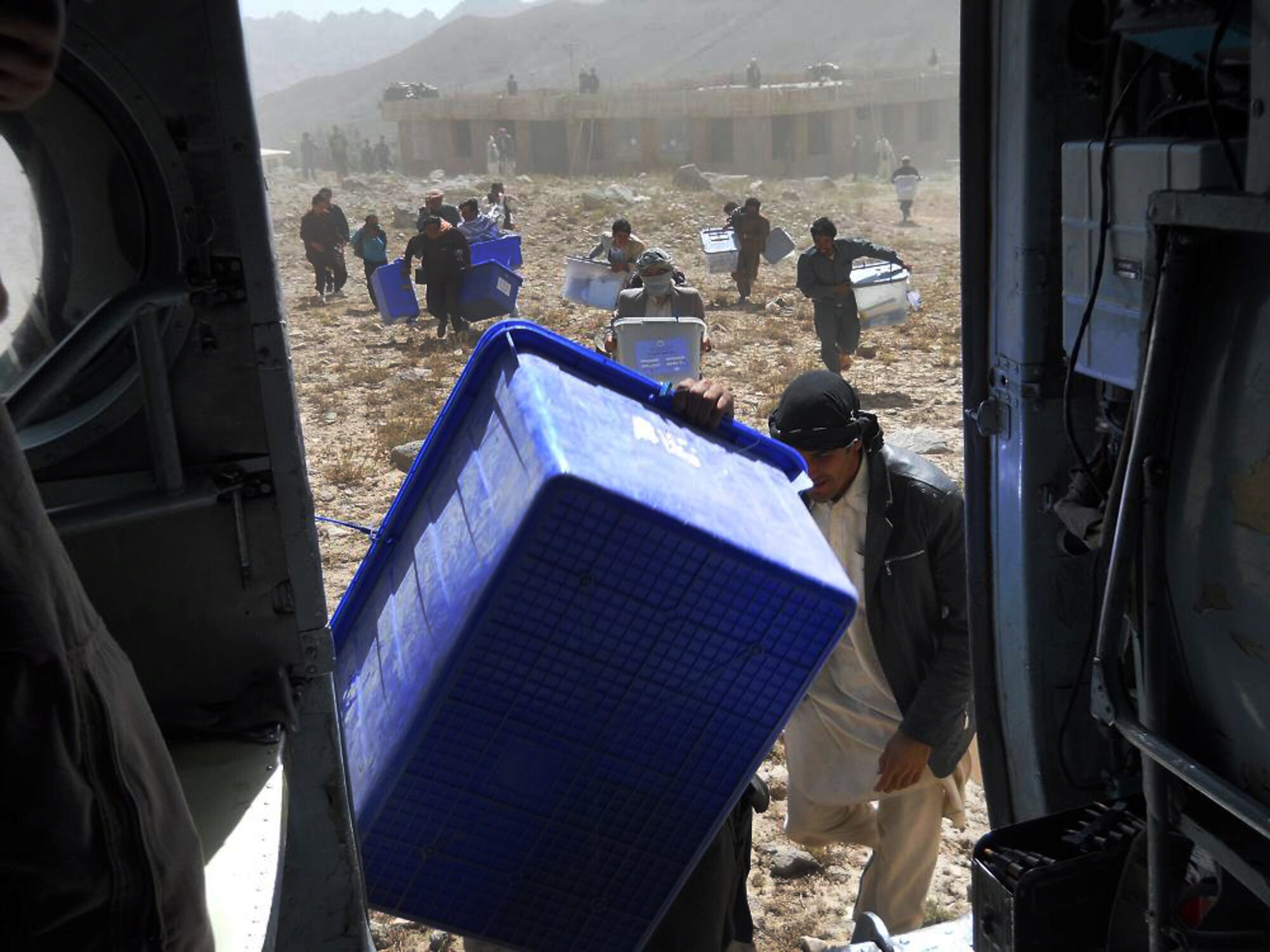 100920-F-4747G-001 KABUL, Afghanistan - Afghan residents of the regions west of Ghazni work to load election ballots onboard Afghan Air Force Mi-17 helicopters on Sep. 20, 2010. The AAF worked long days in order to disseminate ballots to all regions of Afghanistan. These efforts lead to a 40 percent turnout by Afghan citizens. (US Air Force photo by Chief Master Sergeant Max Grindstaff/ RELEASED).