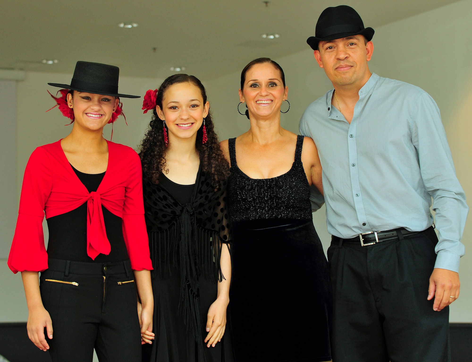 Kelsey Coral and Brianna Judith D'Jesus-Banos, along with Judith Banos-D'Jesus and U.S. Air Force Capt. Ricardo D'Jesus, 86th Medical Group, bioenvironmental engineer, pose for a family portrait after all performing Flamenco, Salsa and Merengue dances during the Hispanic Heritage month kickoff event held at the Kaiserslautern Military Community Center, Ramstein Air Base, Germany, Sept. 18. Both daughters have been performing Jazz, Ballet, Tap and Flamenco for over four years. Capt. and Mrs. D'Jesus, have been performing Salsa and Merengue since the age of twelve. Hispanic Heritage month events celebrate heritage, diversity, integrity and honor and take place from Sept. 15 through Oct. 15 this year. (U.S. Air Force photo by Staff Sgt. Stephen J. Otero)