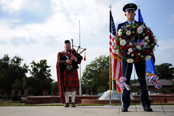 SEYMOUR JOHNSON AIR FORCE BASE, N.C. – Staff Sgt. Jeffery Simmons stands watch over a Prisoner of War – Missing in Action memorial wreath during the 4th Fighter Wing POW/MIA Recognition Ceremony here Sept. 17, 2010. In the background, retired Lt. Col. Norm Taflinger, plays the bagpipes. National POW/MIA Recognition Day is observed each year on the third Friday of September to honor the sacrifices made by POWs and those who are still MIA. (U.S. Air Force photo/ Senior Airman Mackenzie Lang)