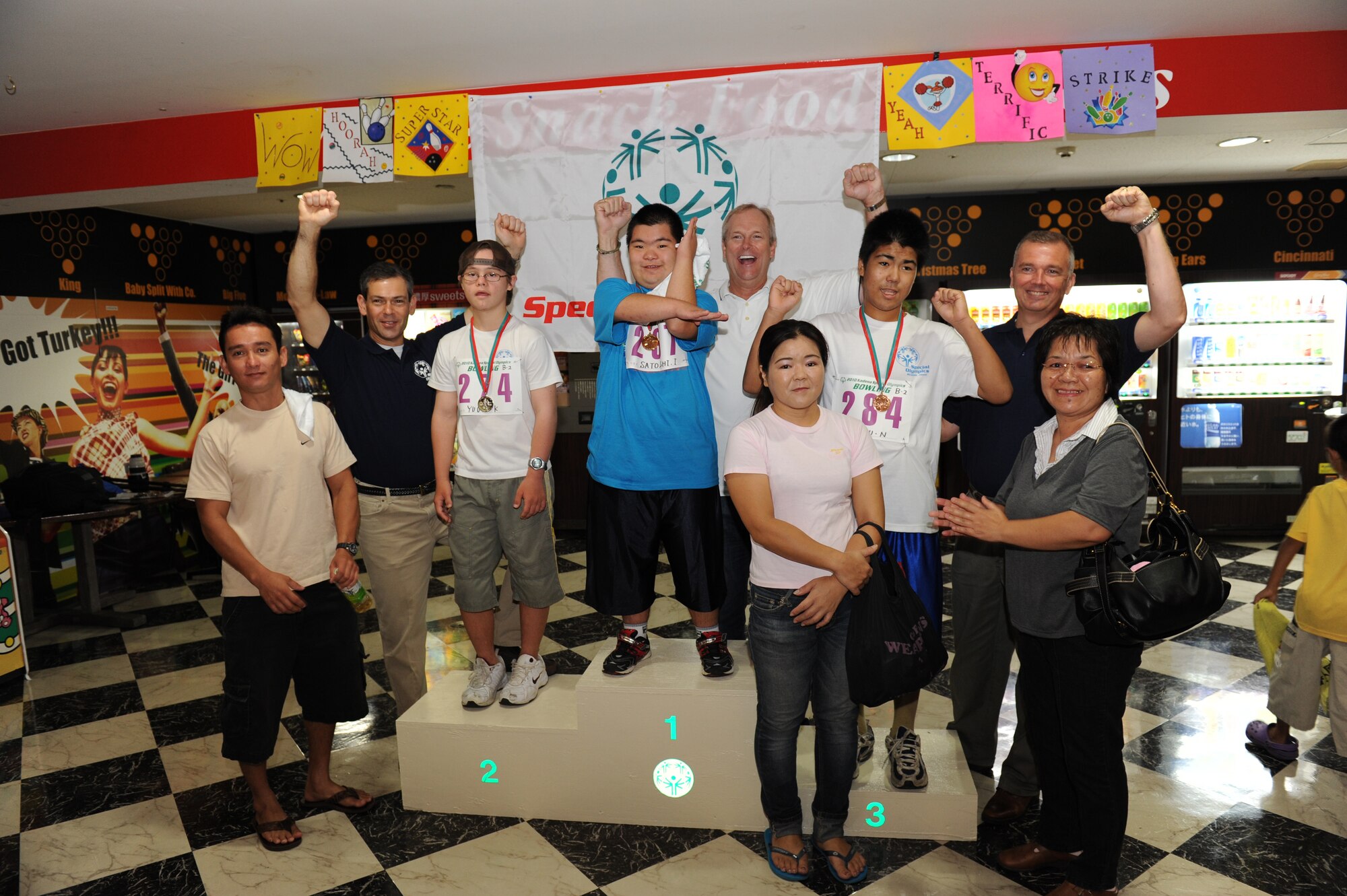 Kadena leadership celebrates a well played round of bowling alongside some of the athletes and family members at the Kadena Special Olympics Bowling event in Mihama, Okinawa, September 18, 2010. The event, attended by more than 300 athletes, volunteers and interpreters, was one of many events leading up to the 11th Annual Kadena Special Olympics, which will be held at Kadena Air Base in November. (U.S. Air Force Photo/Tech Sgt. Jason W. Edwards)