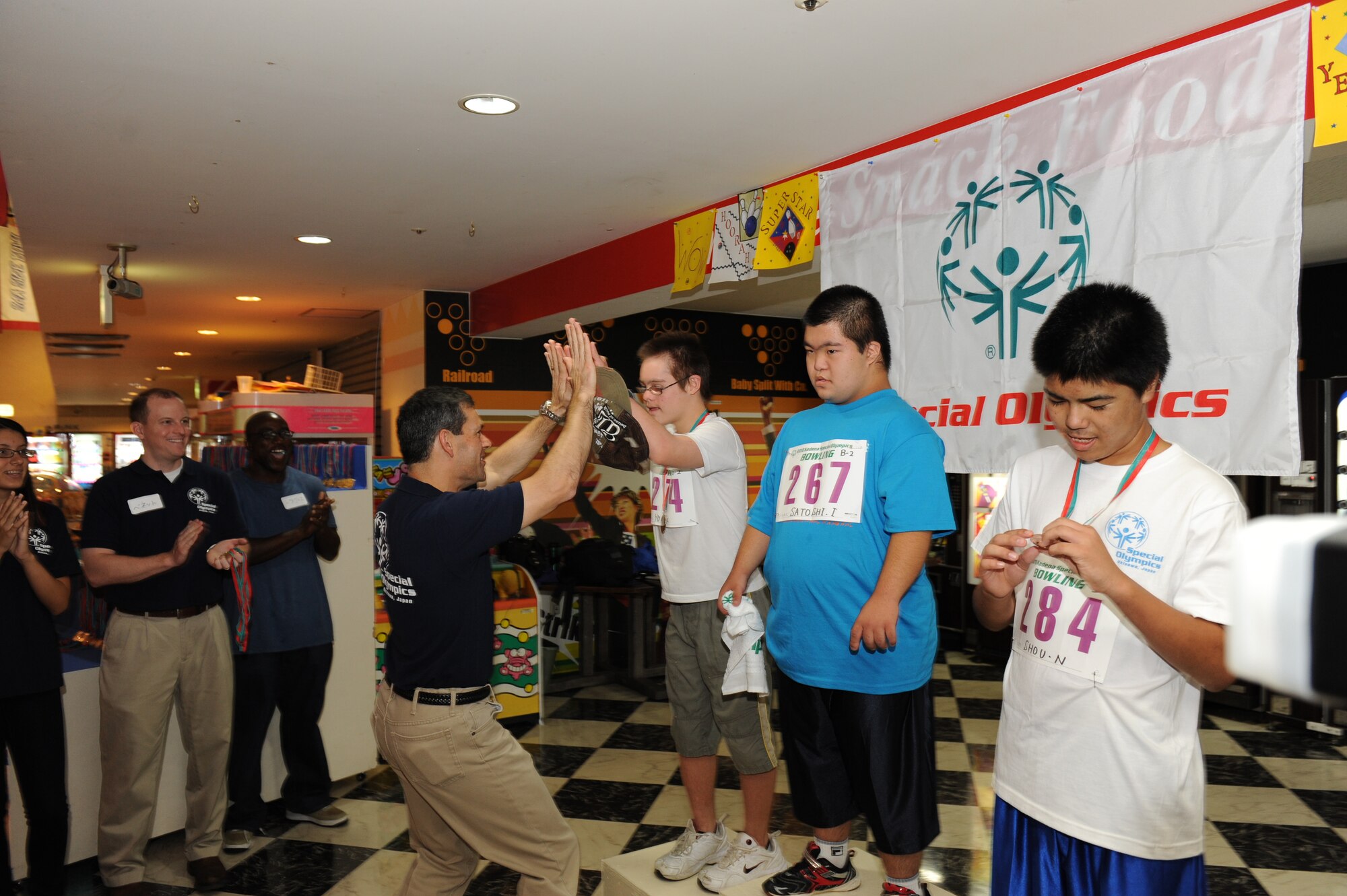 Brigadier General Kenneth Wilsbach, 18th Wing commander, congratulates the athletes at the Kadena Special Olympics Bowling event in Mihama, Okinawa, September 18, 2010. The event, attended by more than 300 athletes, volunteers and interpreters, was one of many events leading up to the 11th Annual Kadena Special Olympics, which will be held at Kadena Air Base in November. (U.S. Air Force Photo/Tech Sgt. Jason W. Edwards)