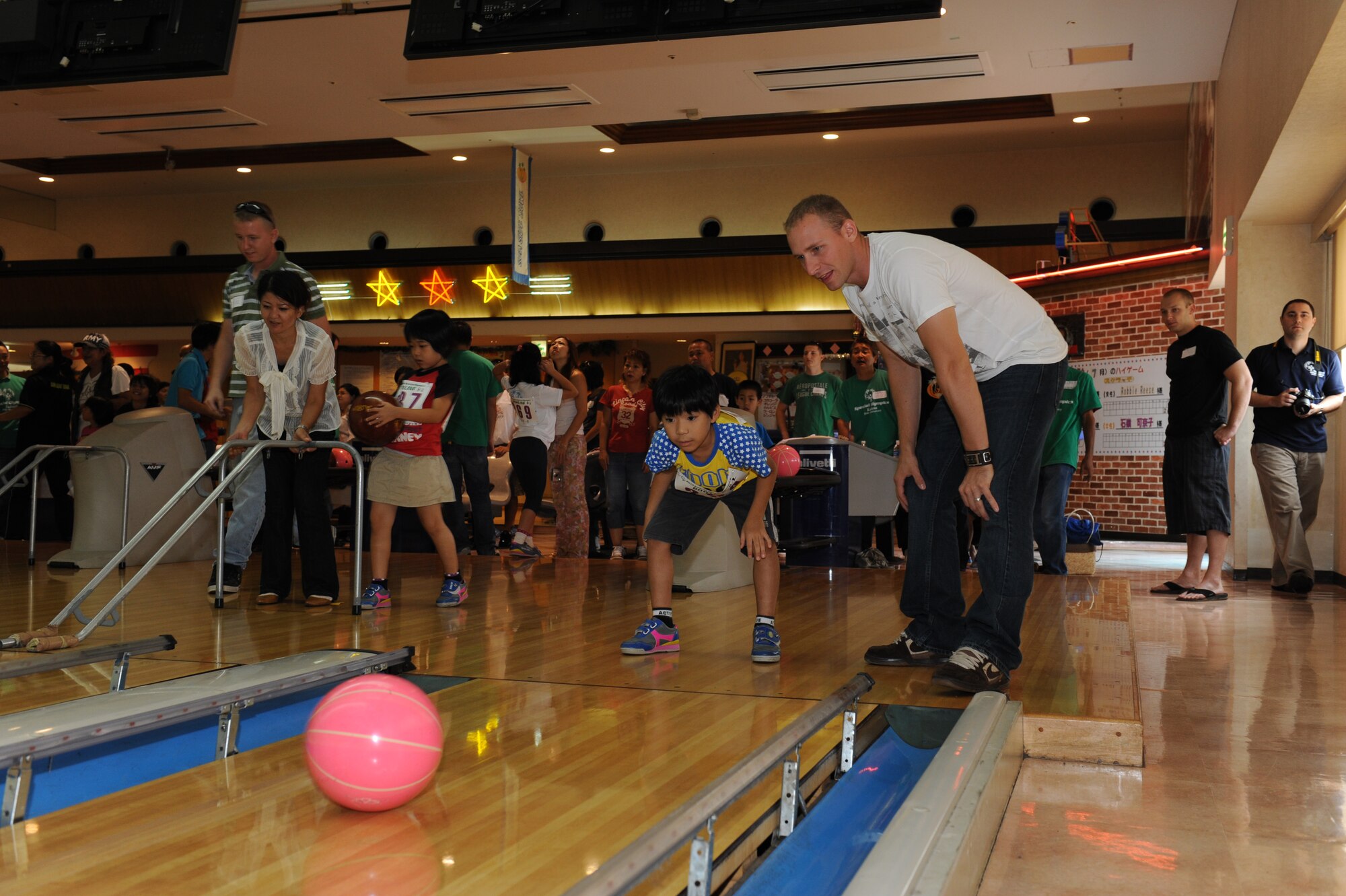 Staff Sgt. Matthew Fultz, 18 Civil Engineer Squadron firefighter, assists Katsuren Tatsuya at the Kadena Special Olympics Bowling event in Mihama, Okinawa, September 18, 2010. The event, attended by more than 300 athletes, volunteers and interpreters, was one of many events leading up to the 11th Annual Kadena Special Olympics, which will be held at Kadena Air Base in November. (U.S. Air Force Photo/Tech Sgt. Jason W. Edwards)