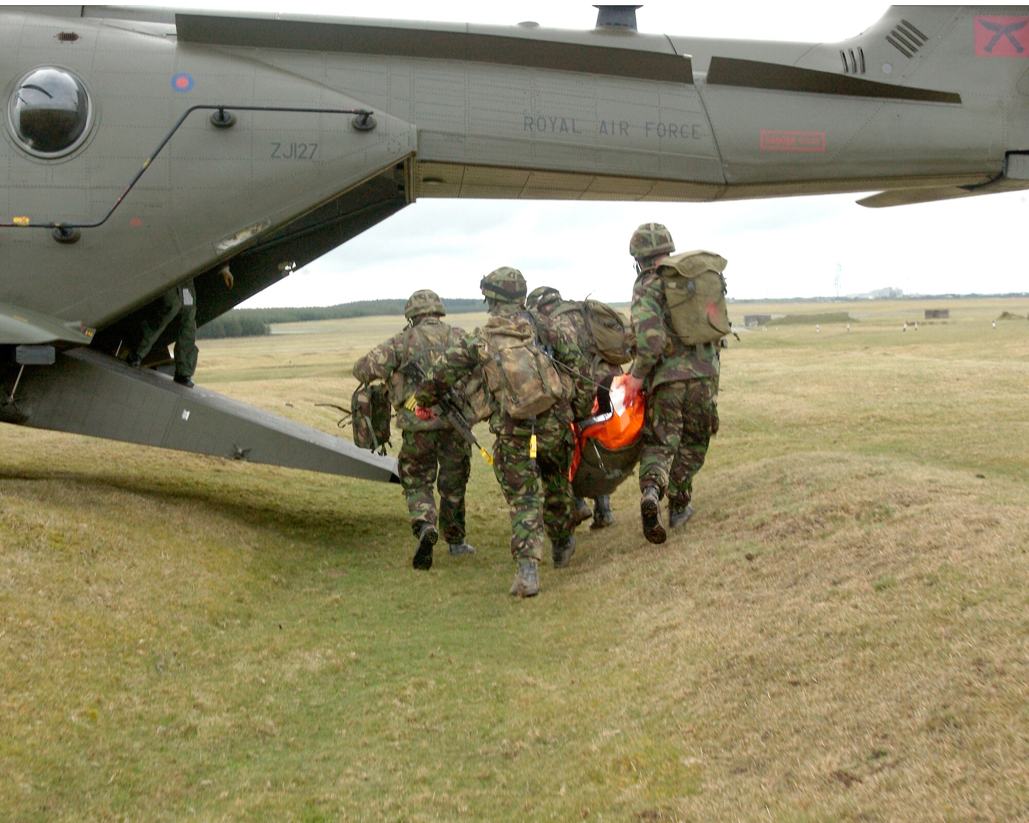 A team of 28 Squadron Royal Air Force Regiment combat medics transport a soldier to a casualty evacuation helicopter during a training scenario at Davidstow, North Cornwall, England. RAF Regiment medics work hand in hand with U.S. Air Force pararescuemen in Southern Afghanistan. (Royal Air Force Photo by RAF Senior Aircraftman Chris Davidson)