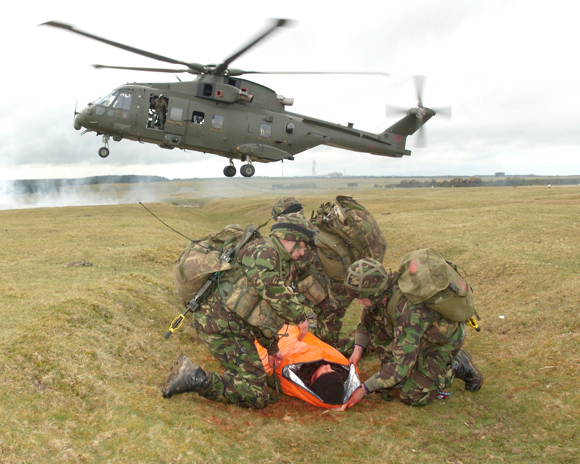 A team of 28 Squadron Royal Air Force Regiment combat medics prepare to transport a 'wounded' soldier to a casualty evacuation helicopter during a training scenario at Davidstow, North Cornwall, England. Realistic combat training is necessary to prepare the medics for combat operations in Southern Afghanistan. (Royal Air Force Photo by RAF Senior Aircraftman Chris Davidson)