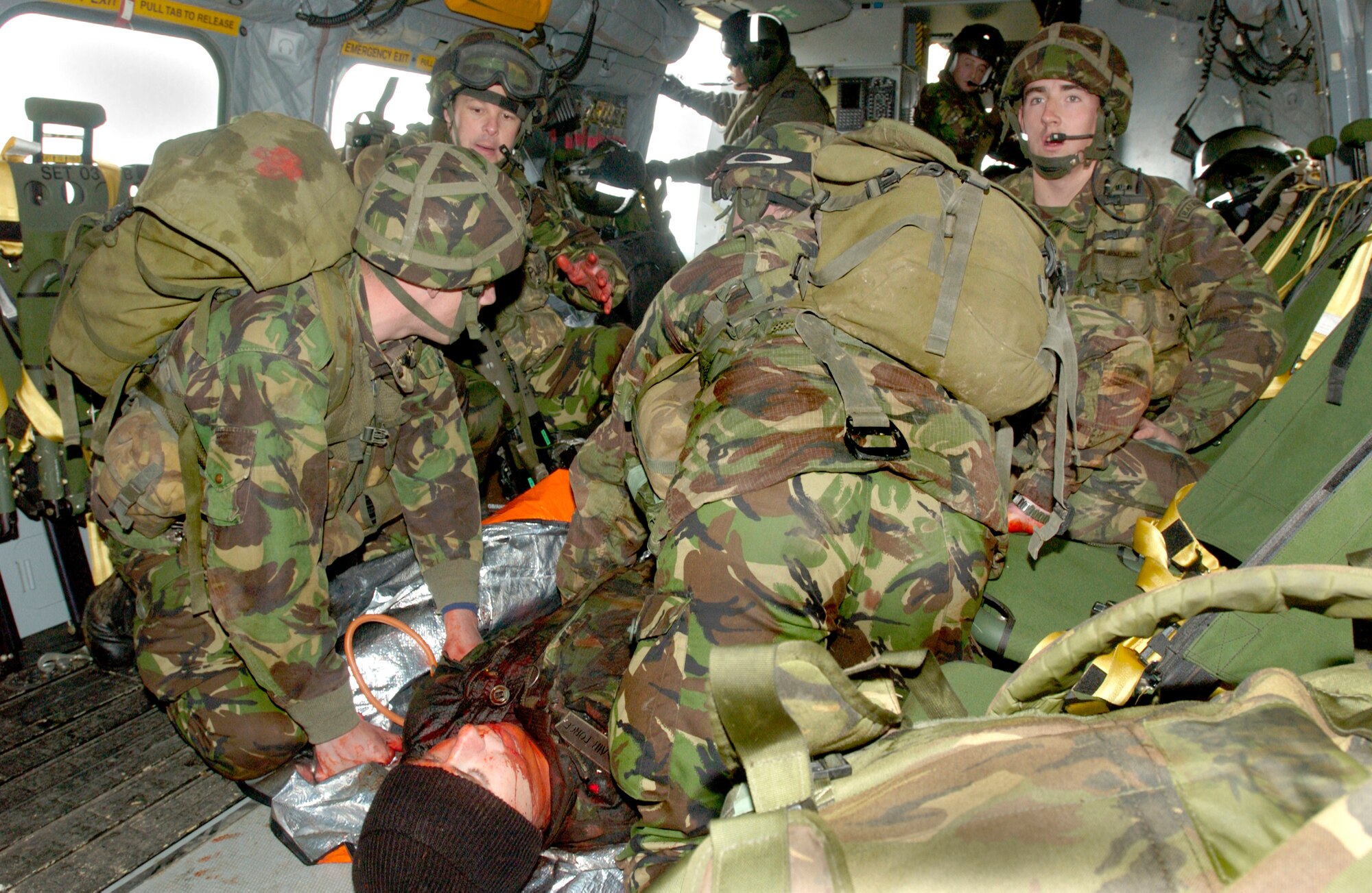 A team of 28 Squadron Royal Air Force Regiment combat medics care for a 'wounded' soldier aboard a casualty evacuation helicopter during a training scenario at Davidstow, North Cornwall, England. The RAF Regiment now uses volunteers who've lost a limb in battle but still want to serve as patients. Utilizing special moulage teams and the fact that the members already have a missing limb, combat medic trainers are able to give their new medics realistic human casualties to treat.  (Royal Air Force Photo by RAF Senior Aircraftman Chris Davidson)