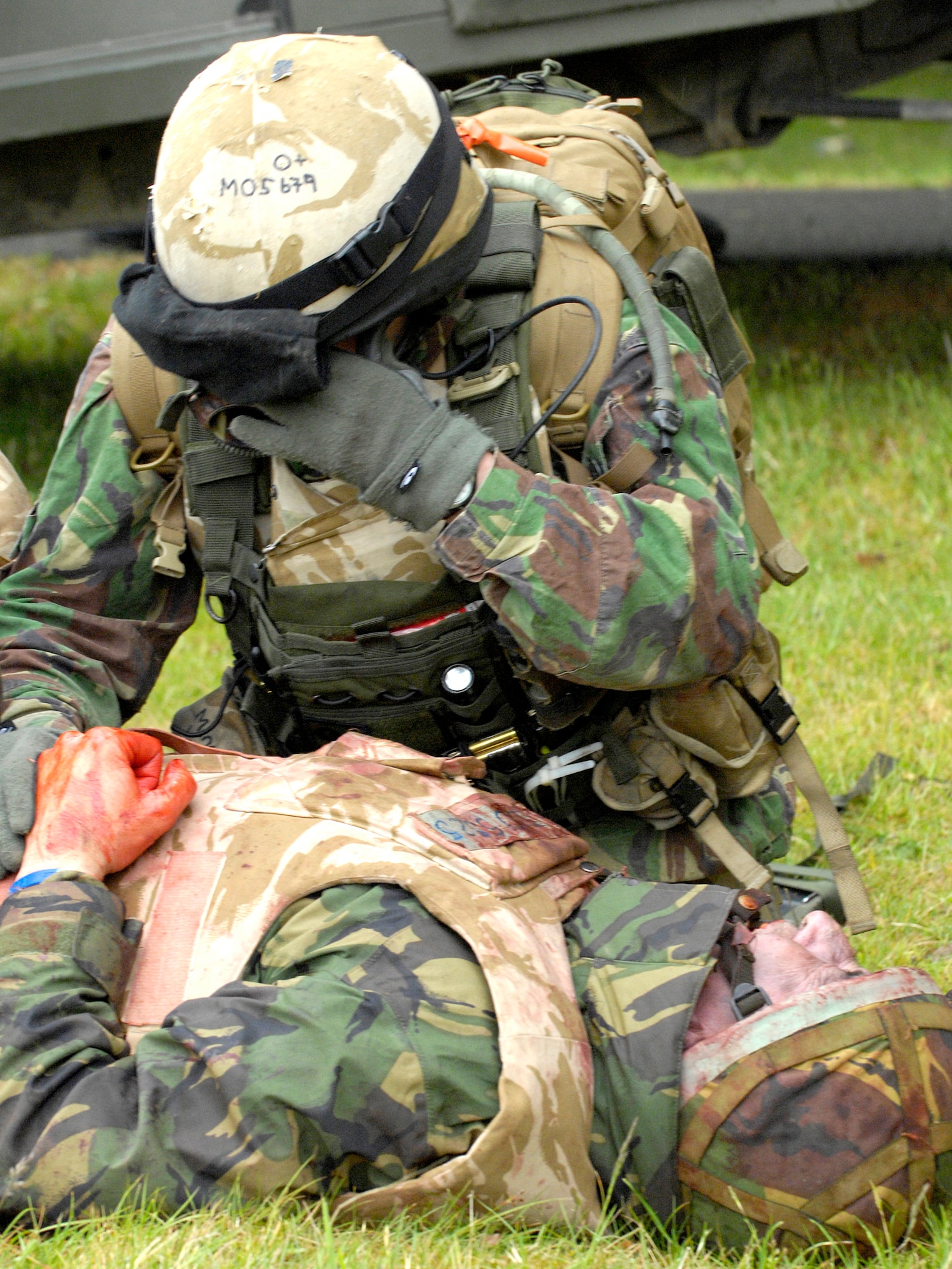 A 51 Squadron Royal Air Force Regiment combat medic from RAF Honington, Norfolk, England, shows signs of fatigue, while treating patients during an exercise combat scenario. The RAF Regiment now uses volunteers who've lost a limb in battle but still want to serve as patients. Utilizing special moulage teams and the fact that the members already have a missing limb, combat medic trainers are able to give their new medics realistic human casualties to treat.  (Royal Air Force Photo)