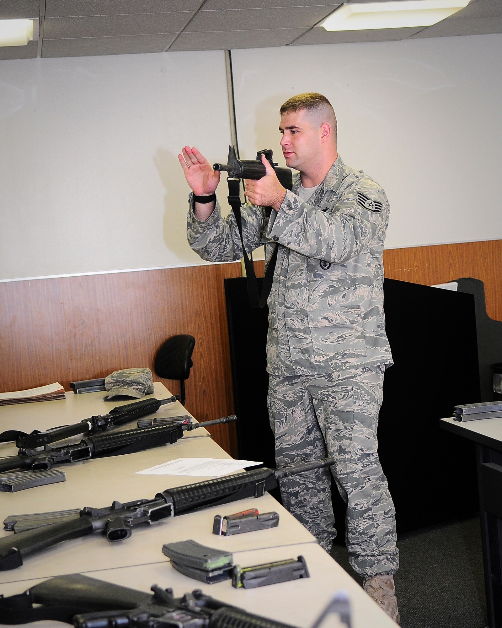YOKOTA AIR BASE, Japan -- Staff Sgt. John Devine, 374th Security Forces Squadron Combat Arms Instructor, teaches 16 Airmen during the classroom portion of the M-16 training class here Sept. 20.  Sergeant Divine gives his students the basic fundimentals of shooting the M-16 during a weapons qualification course designed to help Airmen maintain readiness standards. (U.S. Air Force photo by Staff Sgt. Stacy Moless) 
