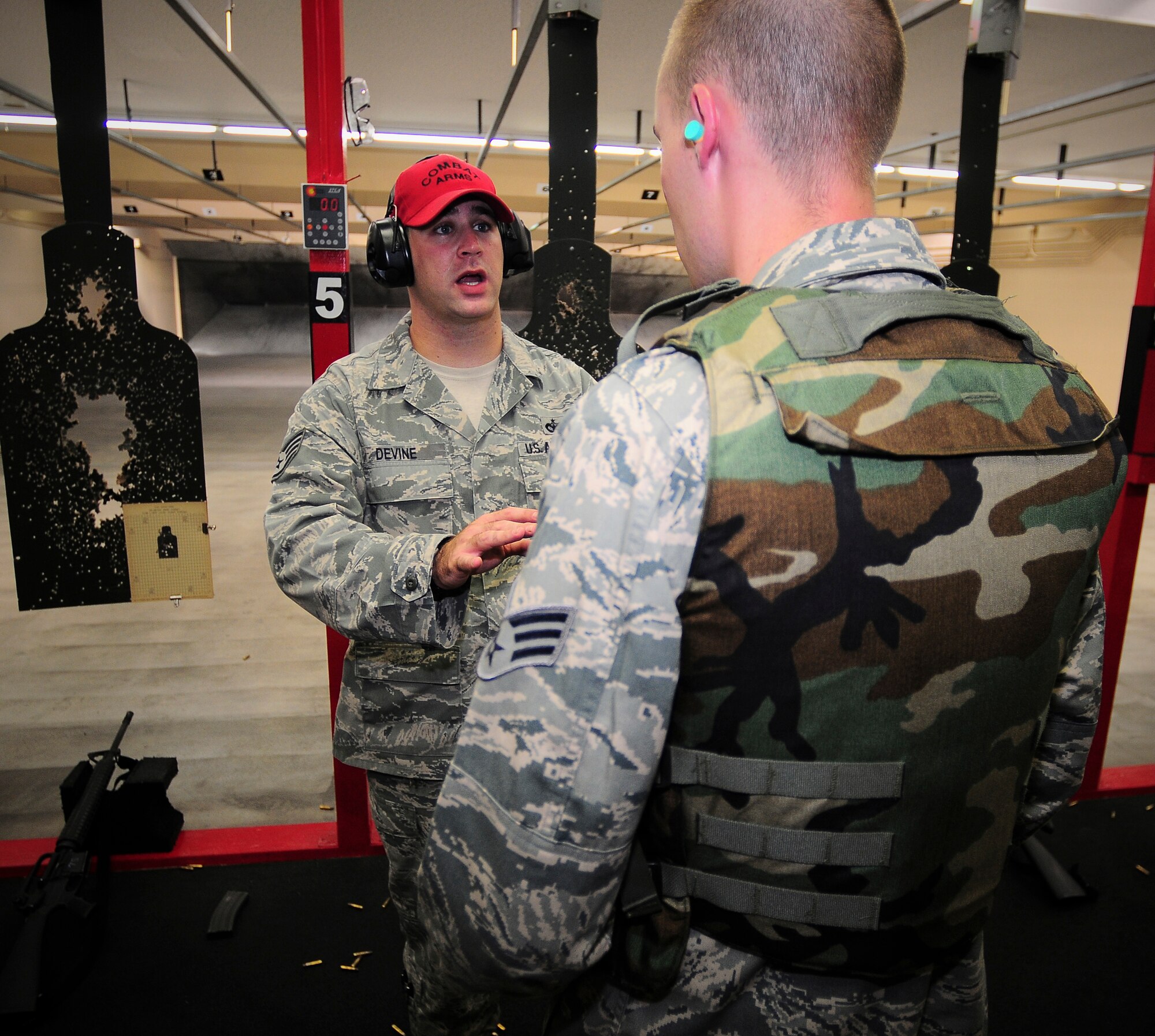 YOKOTA AIR BASE, Japan -- Staff Sgt. John Devine, 374th Security Forces Squadron Combat Arms Instructor, gives Senior Airman Eric Hunsaker, 374th Force Support Squadron, tips on slowing down his breathing to help his aim during an  M-16 training class here Sept. 20. Airmen attended the weapons qualification course to maintain readiness standards. ( U.S. Air Force photo by Staff Sgt. Stacy Moless) 
