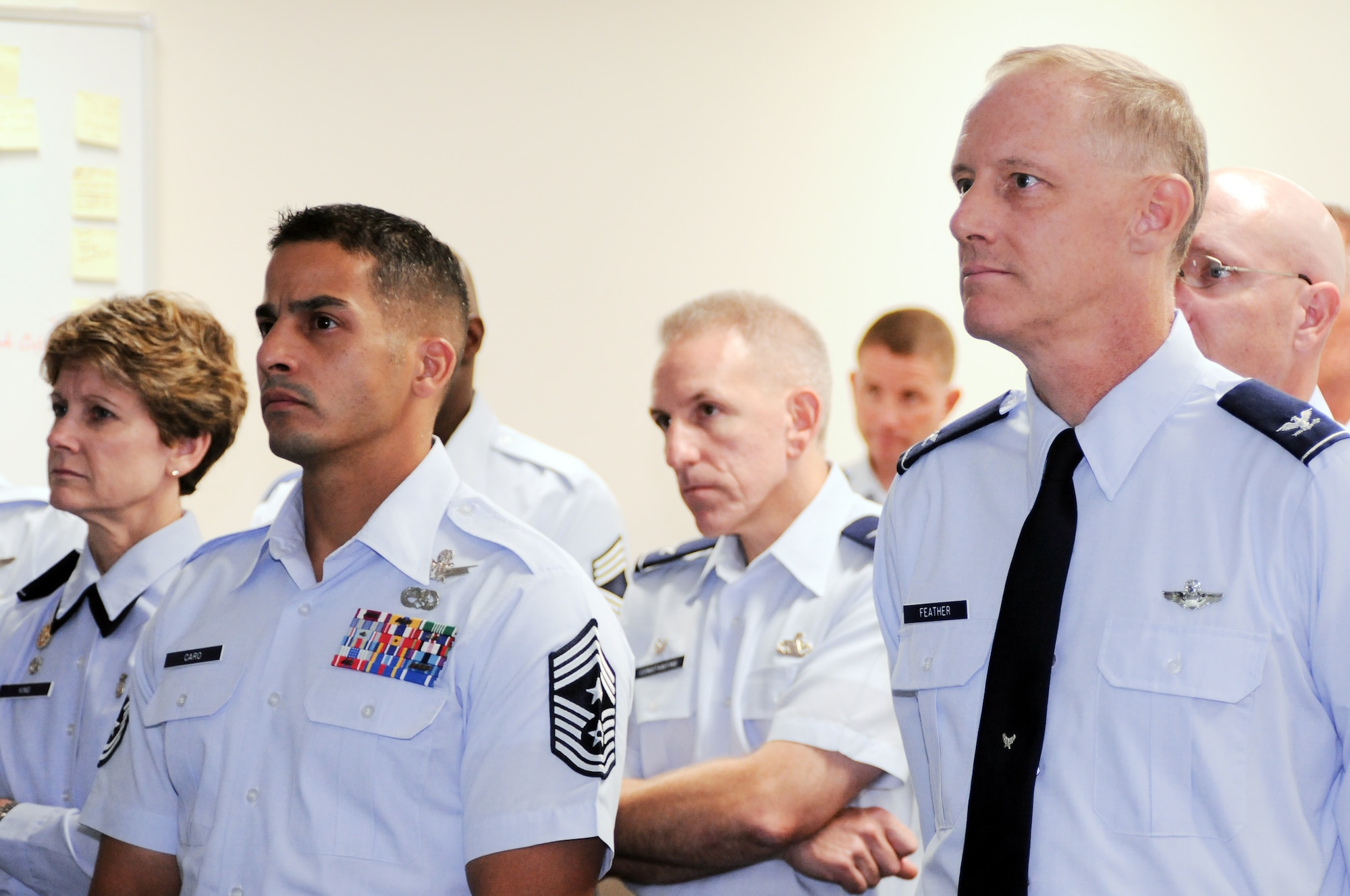 YOKOTA AIR BASE, Japan -- Leaders from Yokota and Kadena Air Bases including Col. Otto Feather, 374th Airlift Wing commander, (right) and Chief Benjamin Caro, 374th AW command chief, (left) watch a presentation from Air Force Smart Operations for the 21st Century during the senior leader’s course for AFSO21, here September 20.  Together the leadership from both bases discussed changes needed to make the cargo deployment process more efficient. (U.S. Air Force Photo/ Airman 1st Class Katrina R. Menchaca)