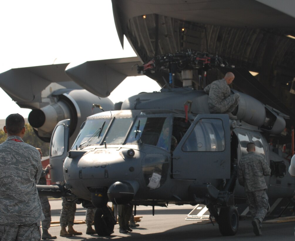 Members of the 106th Rescue Wing from Francis S. Gabreski Air National Guard Base, Westhampton Beach, N.Y., unload an HH-60 Pave Hawk helicopter from a C-17 Globemaster III at the Ysterplaat air force base in South Africa for the Africa Aerospace and Defense 2010 exhibition. The New York National Guard participates in a State Partnership Program with the South African National Defense Force and sent an Army National Guard OH-58 Kiowa Scout helicopter and the Pave Hawk rescue helicopter to participate in the exhibition. U.S. Army photo by Staff Sgt. Inman Frank