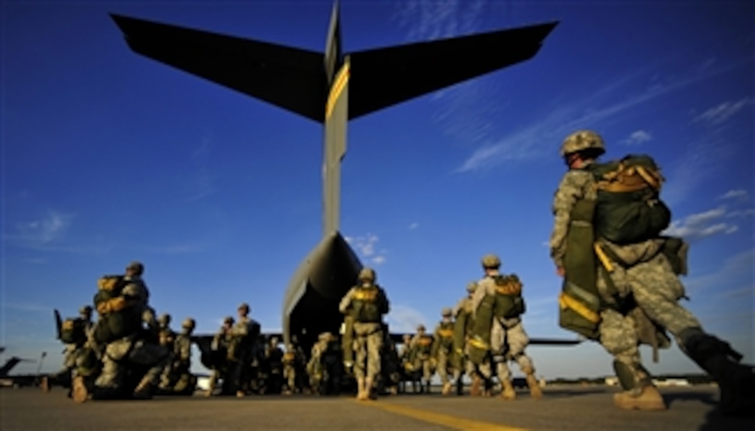 U.S. Army soldiers assigned to the 82nd Airborne Division walk out to a C-17 Globemaster III aircraft prior to a parachute drop during a joint forcible entry exercise at Pope Air Force Base, N.C., on Sept. 14, 2010.  A joint forcible entry training event is held six times a year in order to enhance cohesiveness between the Air Force and the Army.  